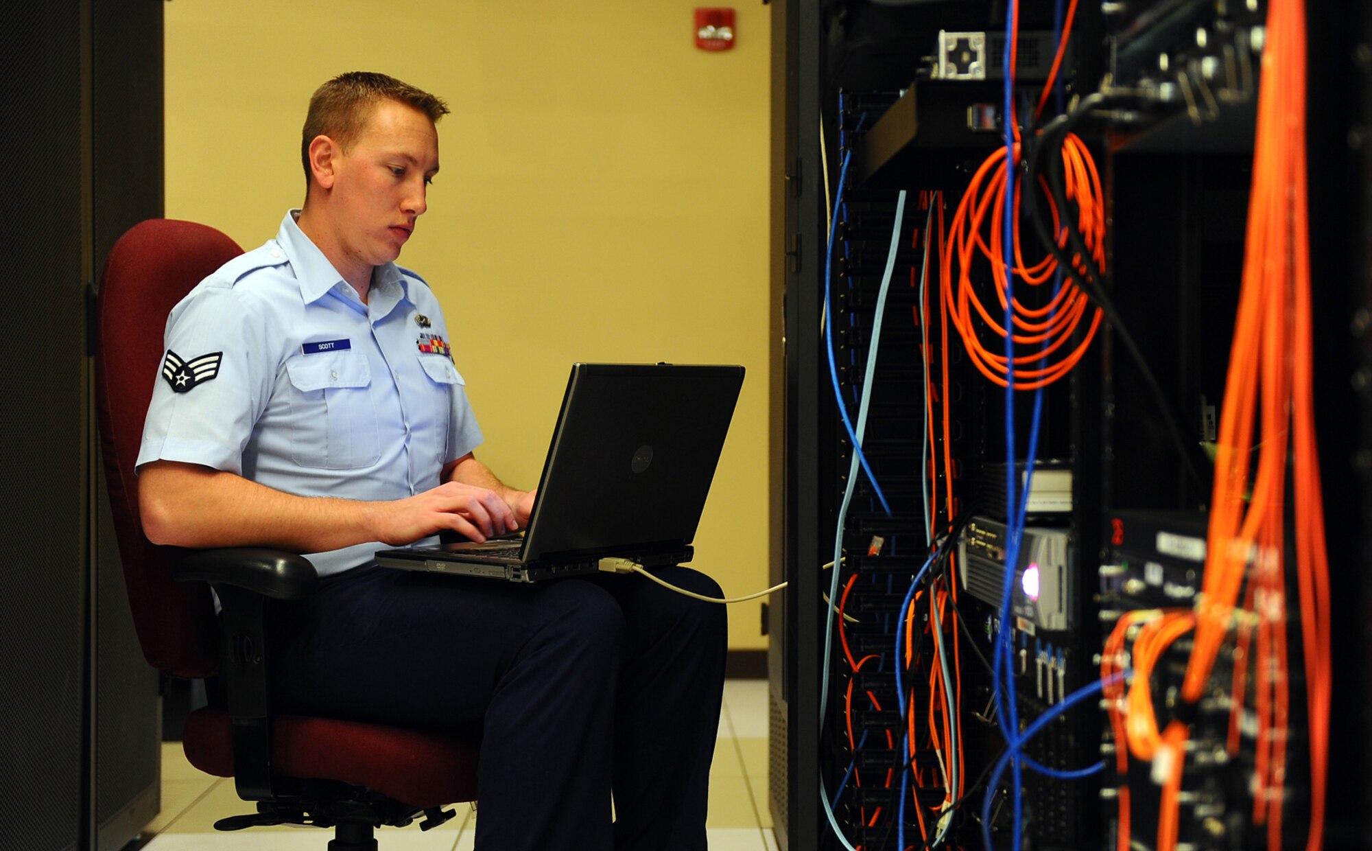 OFFUTT AIR FORCE BASE, Neb. - Senior Airman Dustin Scott, a network infrastructure technician assigned to the Air Force Weather Agency's 2d Systems Operations Squadron here, performs routine observation and maintenance of AFWA's network April 19. Airman Scott was recently announced as the Communications and information Outstanding Communications-Computer Systems award winner. Airman Scott will accept the award in a formal ceremony in Washington D.C., next month. U.S. Air Force photo by Josh Plueger
