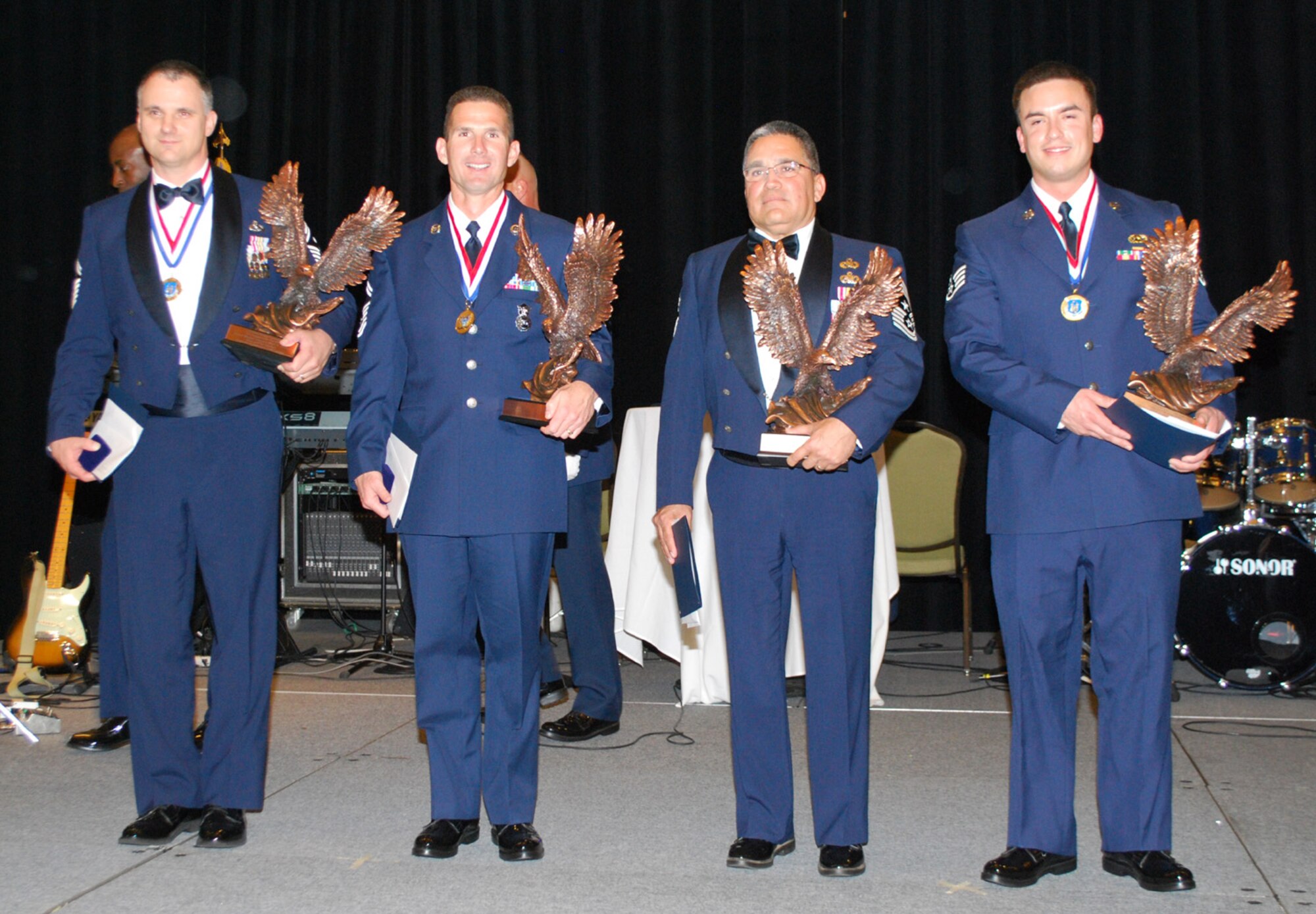 Air Force Reserve Command's Outstanding Airmen of the Year receive their awards at the AFRC annual awards banquet April 14, 2010. From left they are Senior Master Sgt. Mark Barber; Senior Master Sgt. Steven West; 944th Fighter Wing Command Chief Master Sgt. Pablo Valverde Jr., accepting on behalf of Tech. Sgt. Stephen Hunter Jr.; and Staff Sgt. James McKeown. (U.S. Air Force photo/Staff Sgt. Celena Wilson)