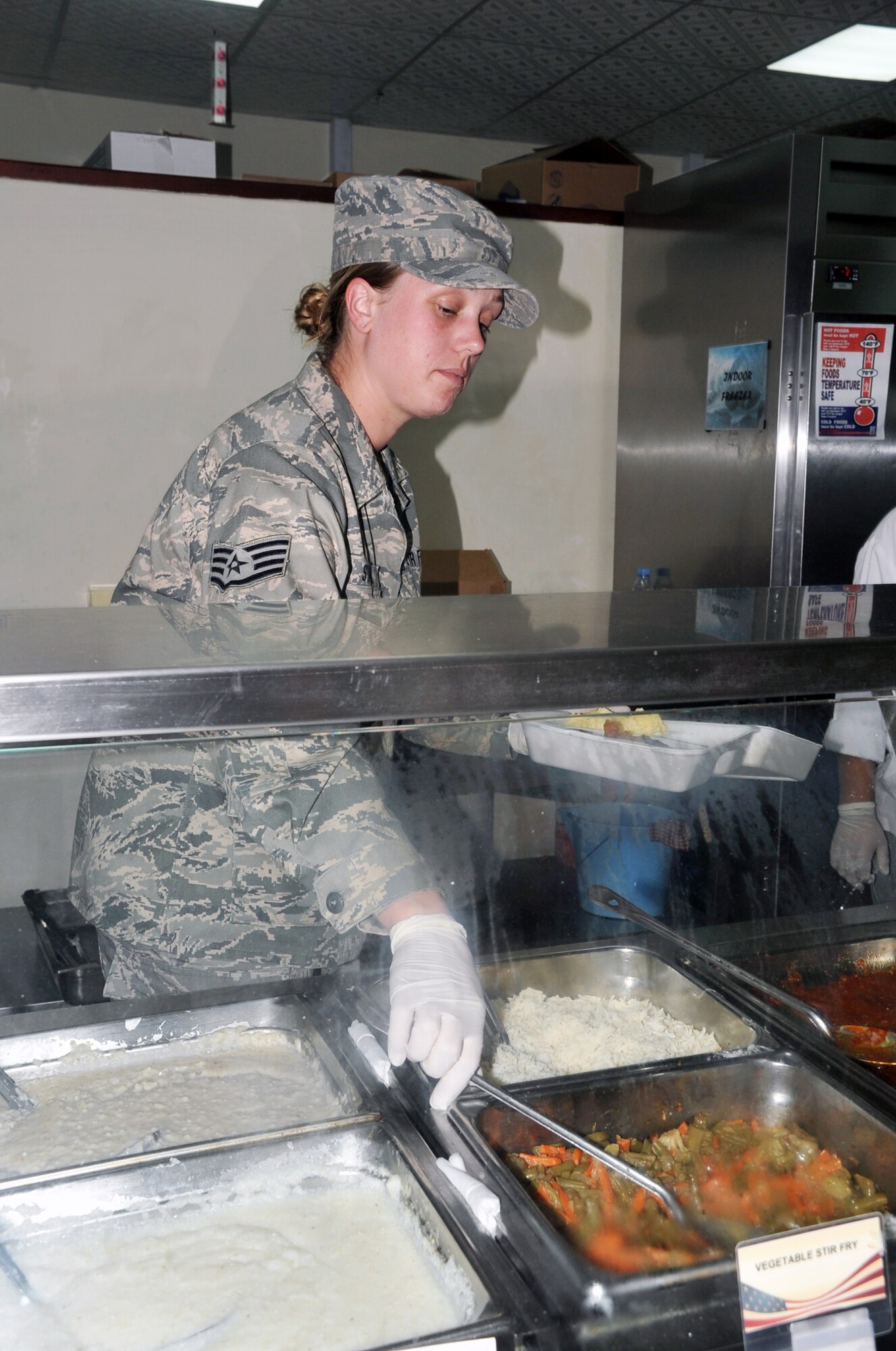 Staff Sgt. Karen Staniek, services journeyman with the 380th Expeditionary Force Support Squadron, works in Roy's flight kitchen in the operations area for the 380th Air Expeditionary Wing at a non-disclosed base in Southwest Asia on April 15, 2010. the 380th EFSS, as part of the 380th Air Expeditionary Wing, supports operations Iraqi Freedom and Enduring Freedom and the Combined Joint Task Force-Horn of Africa. Sergeant Staniek is deployed from the 127th Force Support Squadron at Selfridge Air National Guard Base, and her hometown is ount Sterling Heights, Mich. (U.S. Air Force Photo/Master Sgt. Scott T. Sturkol/Released)