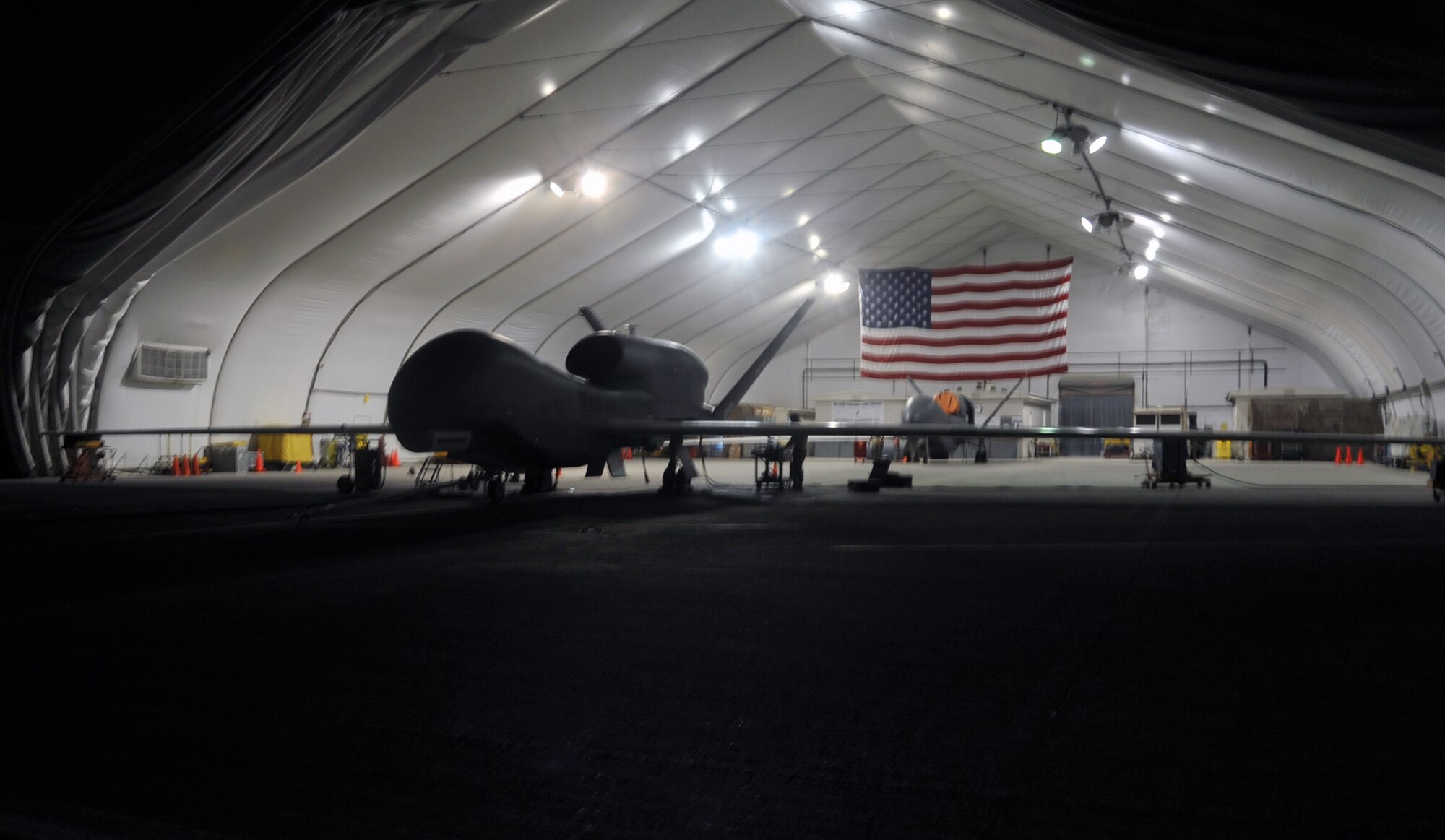 A maintenance technician from the 380th Expeditionary Aircraft Maintenance Squadron's Global Hawk aircraft maintenance unit works on a Global Hawk during operations on the flightline April 15, 2010, at a non-disclosed base in Southwest Asia. The RQ-4 is assigned to the 99th Expeditionary Reconnaissance Squadron and deployed from Beale Air Force Base, Calif. The RQ-4 Global Hawk is a high-altitude, long-endurance unmanned aircraft system with an integrated sensor suite that provides intelligence, surveillance and reconnaissance, or ISR, capability worldwide. Global Hawk's mission is to provide a broad spectrum of ISR collection capability to support joint combatant forces in worldwide peacetime, contingency and wartime operations. The 380th EAMXS and 99th ERS, as part of the 380th Air Expeditionary Wing, supports operations Iraqi Freedom and Enduring Freedom and the Combined Joint Task Force-Horn of Africa. (U.S. Air Force Photo/Master Sgt. Scott T. Sturkol/Released)