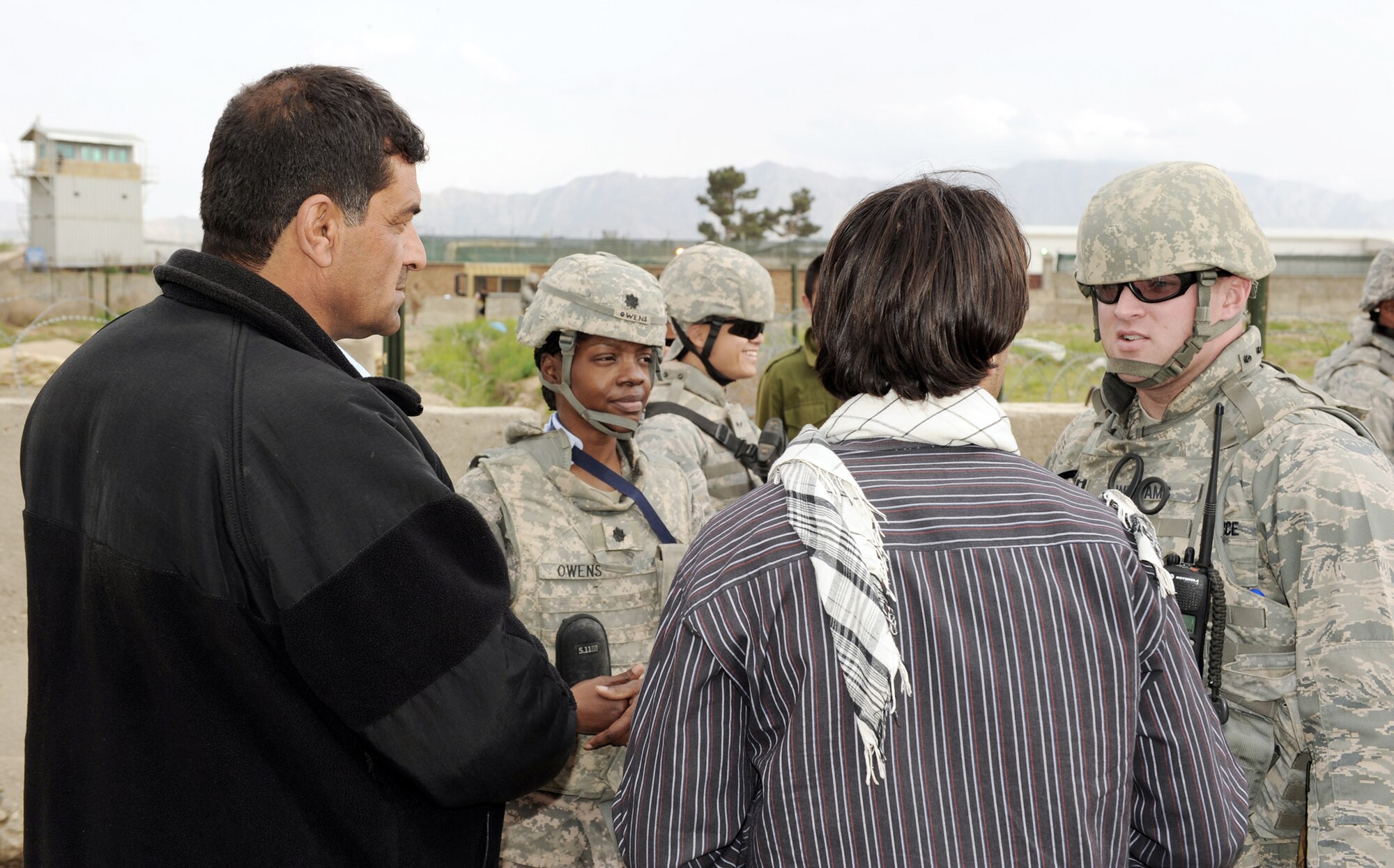 Army Lt. Col. Terry Owens and Capt. Jason Williams discuss item distribution with a village elder and an interpreter during a recent Operation Care humanitarian aid mission April 5, 2010, outside of Bagram Airfield, Afghanistan. Colonel Owens is the Operation Care president from the 30th Medical Command. Captain Williams is from the 455th Expeditionary Security Forces. (U.S. Air Force photo/Staff Sgt. Richard Williams) 
