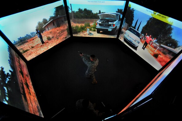 JOINT BASE MCGUIRE-DIX-LAKEHURST, N.J. – Capt. Kevin Snow, 818th Global Mobility Squadron Assistant Operations Officer, exchanges gunfire with an attacker during a training scenario in the 621st Contingency Response Wing’s new virtual firearms training simulator here April 15. The 300-degree field-of-view trains Airmen to anticipate and react appropriately to threats from any direction.   (U.S. Air Force photo/Tech. Sgt Parker Gyokeres)

