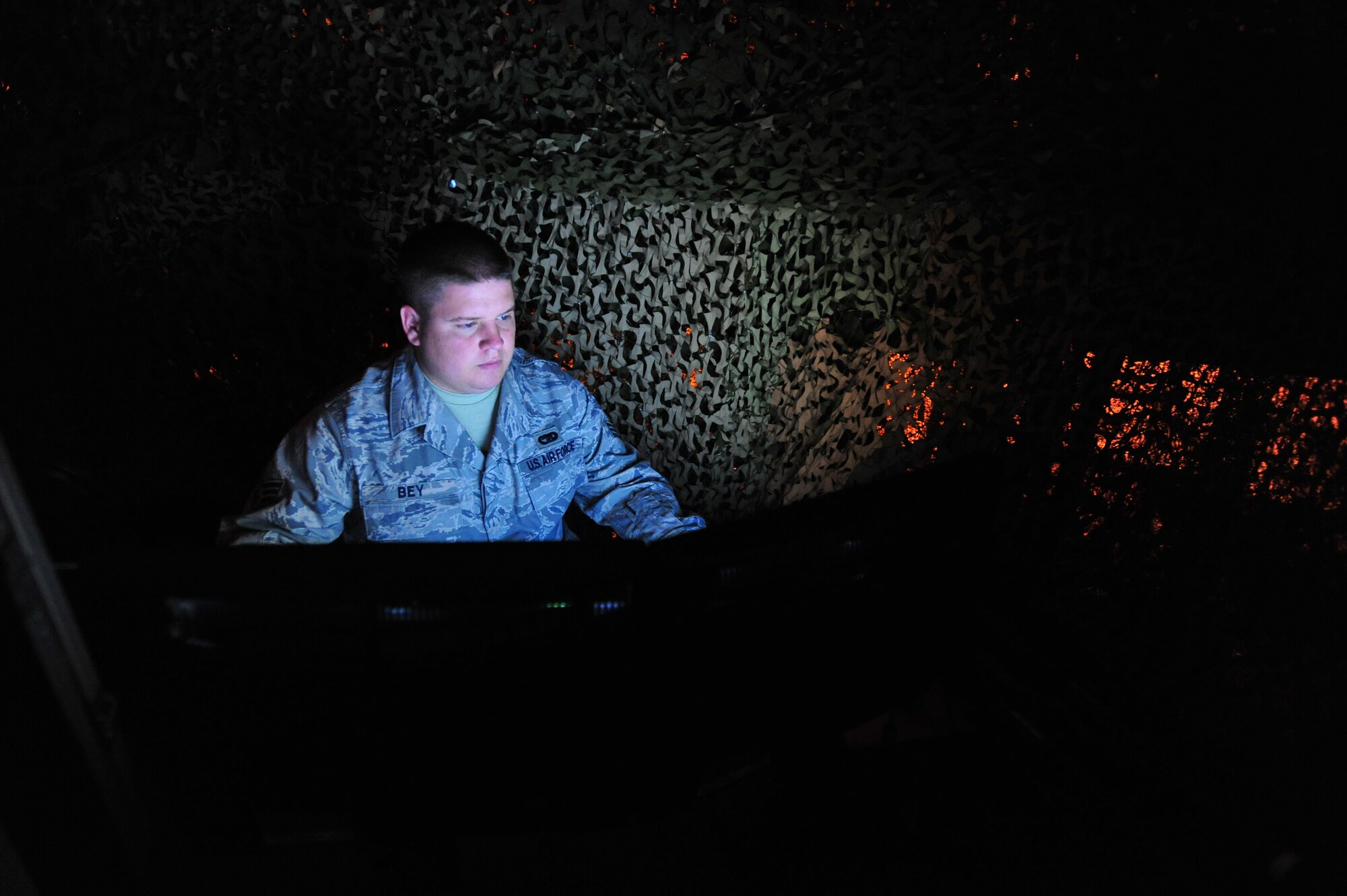 JOINT BASE MCGUIRE-DIX-LAKEHURST, N.J. -- Senior Airman Jeremy Bey, 819th Global Support Squadron Force Protection Trainer, operates the 621st Contingency Response Wing’s new virtual firearms training simulator here April 15.  The $250,000 system uses light sensors and sophisticated image processors to create an immersive reactive training environment.  (U.S. Air Force photo/Tech. Sgt Parker Gyokeres)