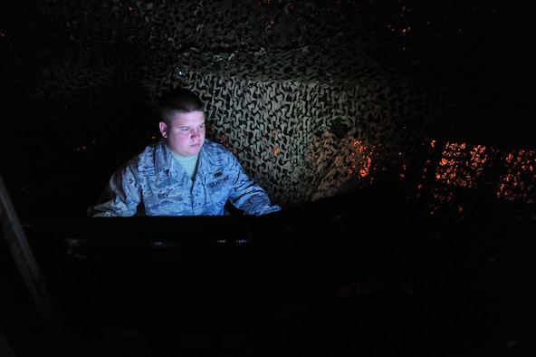 JOINT BASE MCGUIRE-DIX-LAKEHURST, N.J. -- Senior Airman Jeremy Bey, 819th Global Support Squadron Force Protection Trainer, operates the 621st Contingency Response Wing’s new virtual firearms training simulator here April 15.  The $250,000 system uses light sensors and sophisticated image processors to create an immersive reactive training environment.  (U.S. Air Force photo/Tech. Sgt Parker Gyokeres)