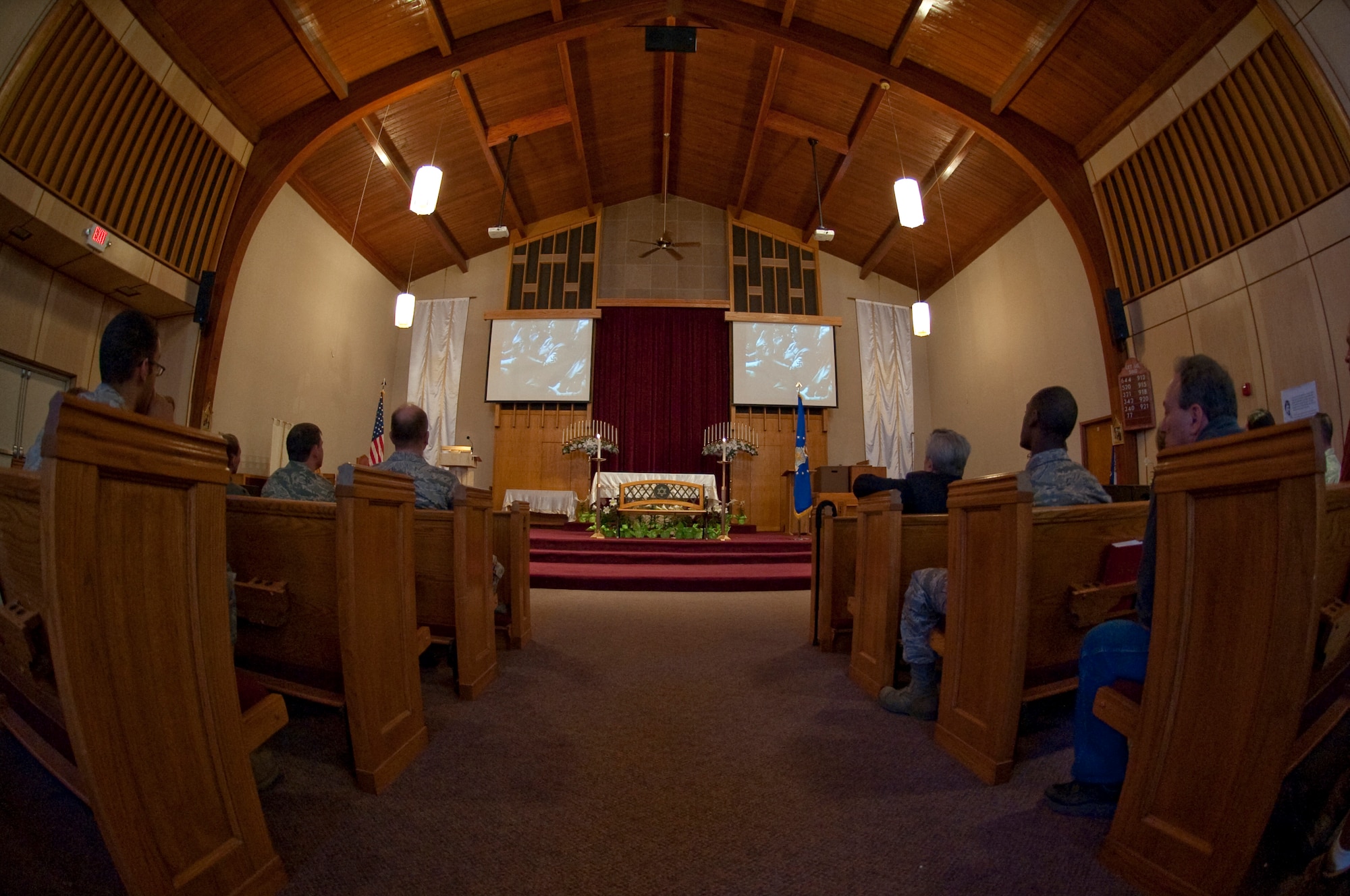 HOLLOMAN AIR FORCE BASE, N.M. -- Members of Team Holloman watch a short video presentation from the U.S. Holocaust Museum titled "Why We Remember the Holocaust," during the annual Holocaust Remembrance ceremony April 6, 2010, at the base chapel. The ceremony was in honor of the day of remembrance designed to commemorate the victims of the Holocaust -- the persecution and extermination of European Jews by Nazi Germany during World War II. Speakers of the event also urged the attendees to not only memorialize the victims, but to reaffirm their commitment to moral obligations as human beings to stand up for justice in order to secure a better future. (U.S. Air Force photo by Airman 1st Class Sondra Escutia / Released)