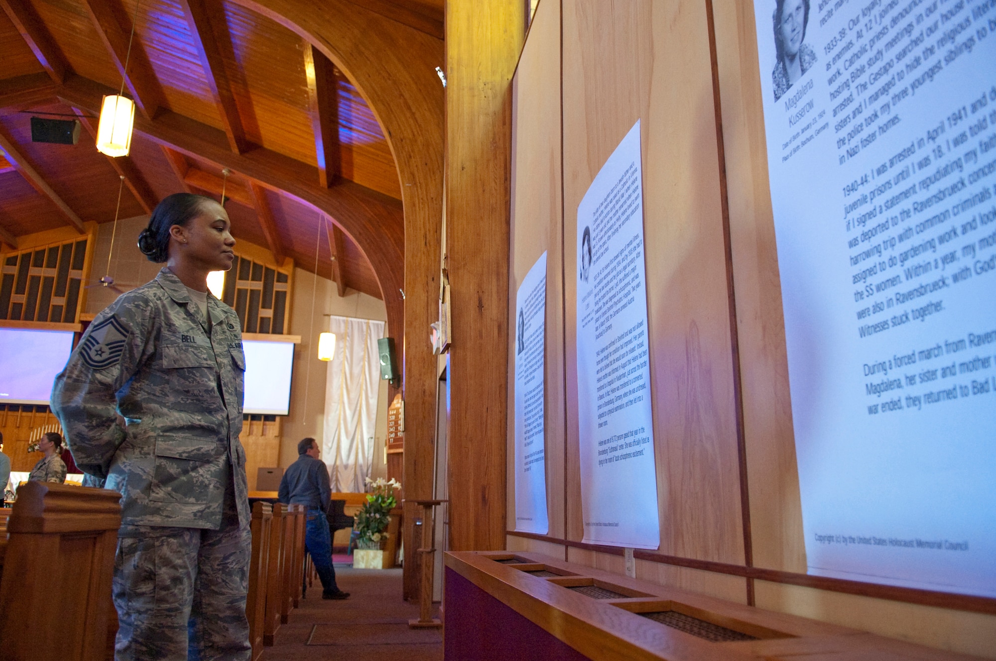 HOLLOMAN AIR FORCE BASE, N.M. -- Senior Master Sgt. Natalie Bell, 49th Fighter Wing, reads the story of a Holocaust victim during the annual Holocaust Remembrance ceremony April 6, 2010, at the base chapel. Stories of victims lined the walls of the chapel for patrons to view and learn from each of their experiences during the Nazi regime in World War II. (U.S. Air Force photo by Airman 1st Class Sondra Escutia/Released)