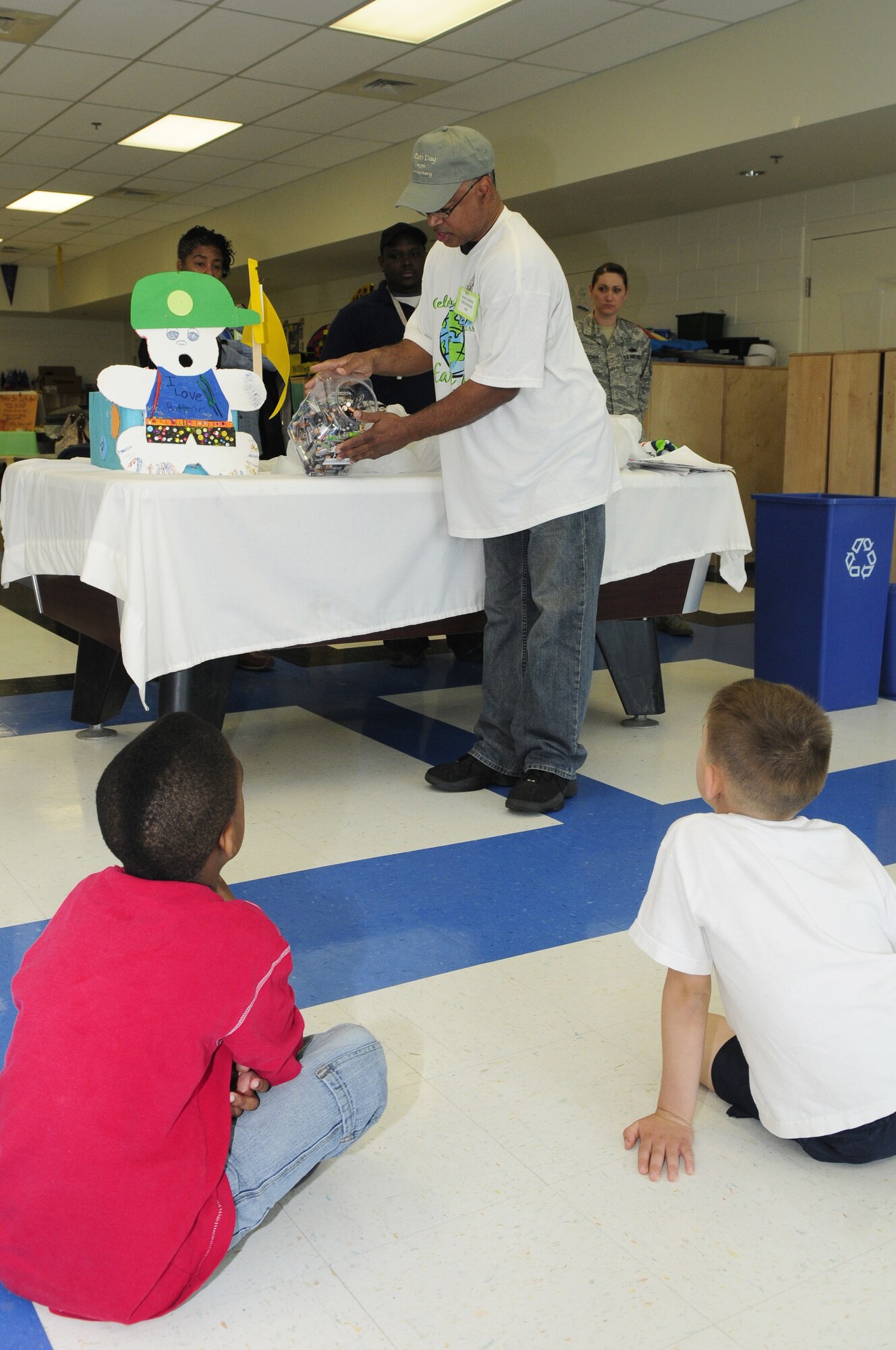 Phil Williams, 11th Civil Engineer Squadron, hosts a battery recycling presentation April 16 at the Bolling AFB Youth Center. More than 1,000 batteries were collected from several collection points on base, including the youth center. The presentation was one of several Earth Day events throughout the month of April, as well as a tree planting event, a green products display at Office Eagle, the base exchange and commissary and an Earth Day party at the Slip Inn. (U.S. Air Force photo by Staff Sgt. Raymond Mills)