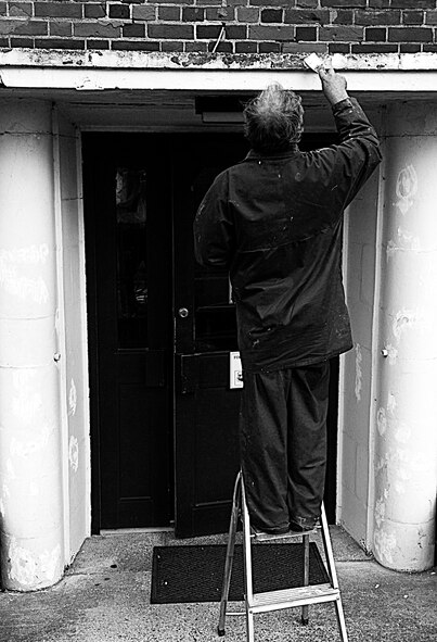 RAF MILDENHALL, England – Ivan Howard, 100th Civil Engineer Squadron, applies a cement filling compound before repainting the entryway of the Airman and Family Readiness Center April 19.  As Earth Week kicks off the base begins spring cleaning and repairing winter-worn buildings.  (U.S. Air Force photo/Staff Sgt. Christopher L. Ingersoll)