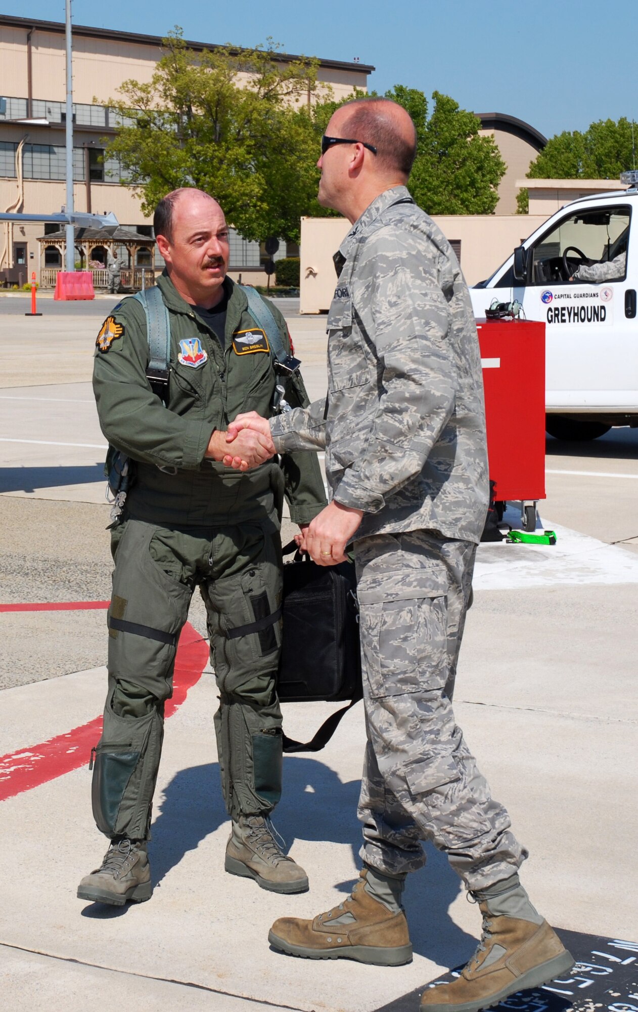 Col. Andrew Donnelly, 113WG Maintenance Group Commander, greets Lt. Col. Ben Breslin, New Mexico Air National Guard, who delivered a newer F-16 from New Mexico to its new home with the DC Air National Guard, April 15. (U.S. Air Force photo by Tech. Sgt Tyrell Heaton/Released)