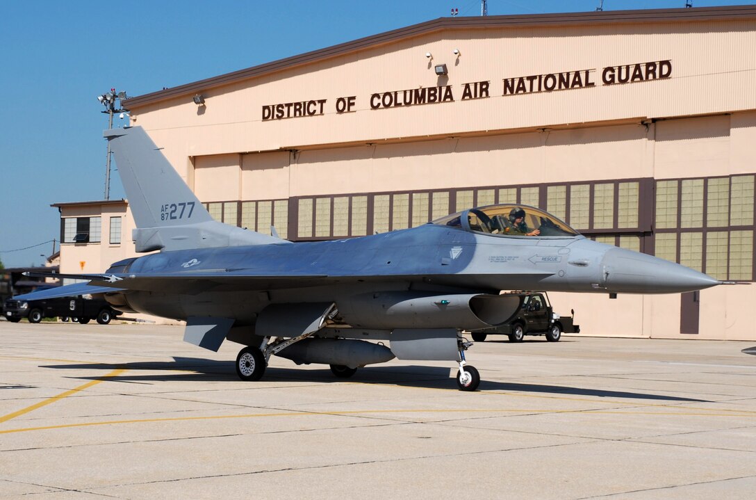 Maj. Matt Shaw, New Mexico Air National Guard, delivers one of two newer "large mouth" F-16s to its new home with the 113th Wing, Joint Base Andrews, April 15. (U.S. Air Force photo by Tech. Sgt Tyrell Heaton/Released)