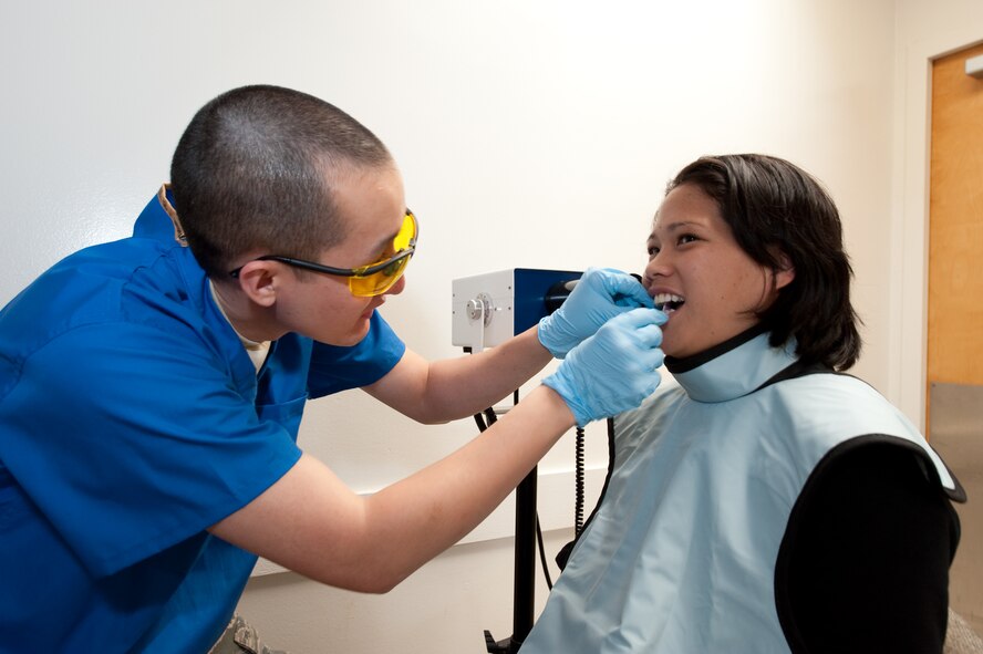 Senior Airman James Wheatley, Dental Technician, 140th Medical Group, Buckley Air Force Base, Colorado Air National Guard, sets a bite-wing in the mouth of Leeyen Lobendahn for a dental x-ray, at Kahuku Medical Center, Hawaii, March 18, 2010. (U.S. Air Force photo/Master Sgt. John Nimmo, Sr.) (RELEASED)