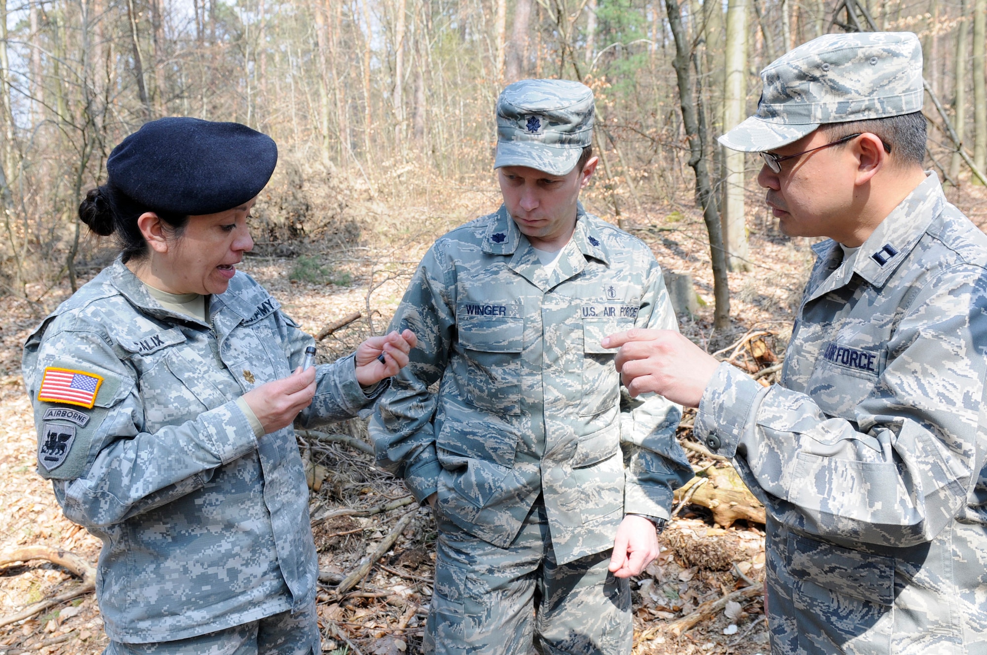 (Left to right) U.S. Army Maj. Lesly Calix, U.S. Army Public Health Command Region-Europe medical entomologist, U.S. Air Force Lt. Col. Kirk Winger, flight commander and Capt. Phillipp Lim, flight operations chief, 86th Aerospace Medical Squadron public health, discuss ticks they have found in various areas, Ramstein Air Base, Germany, April 16, 2010. The 86th AMDS public health flight on Ramstein has been working with the USAPHCEUR to conduct surveillance of tick species and tick-borne pathogens in the area. (U.S. Air Force photo by Airman 1st Class Brittany Perry)