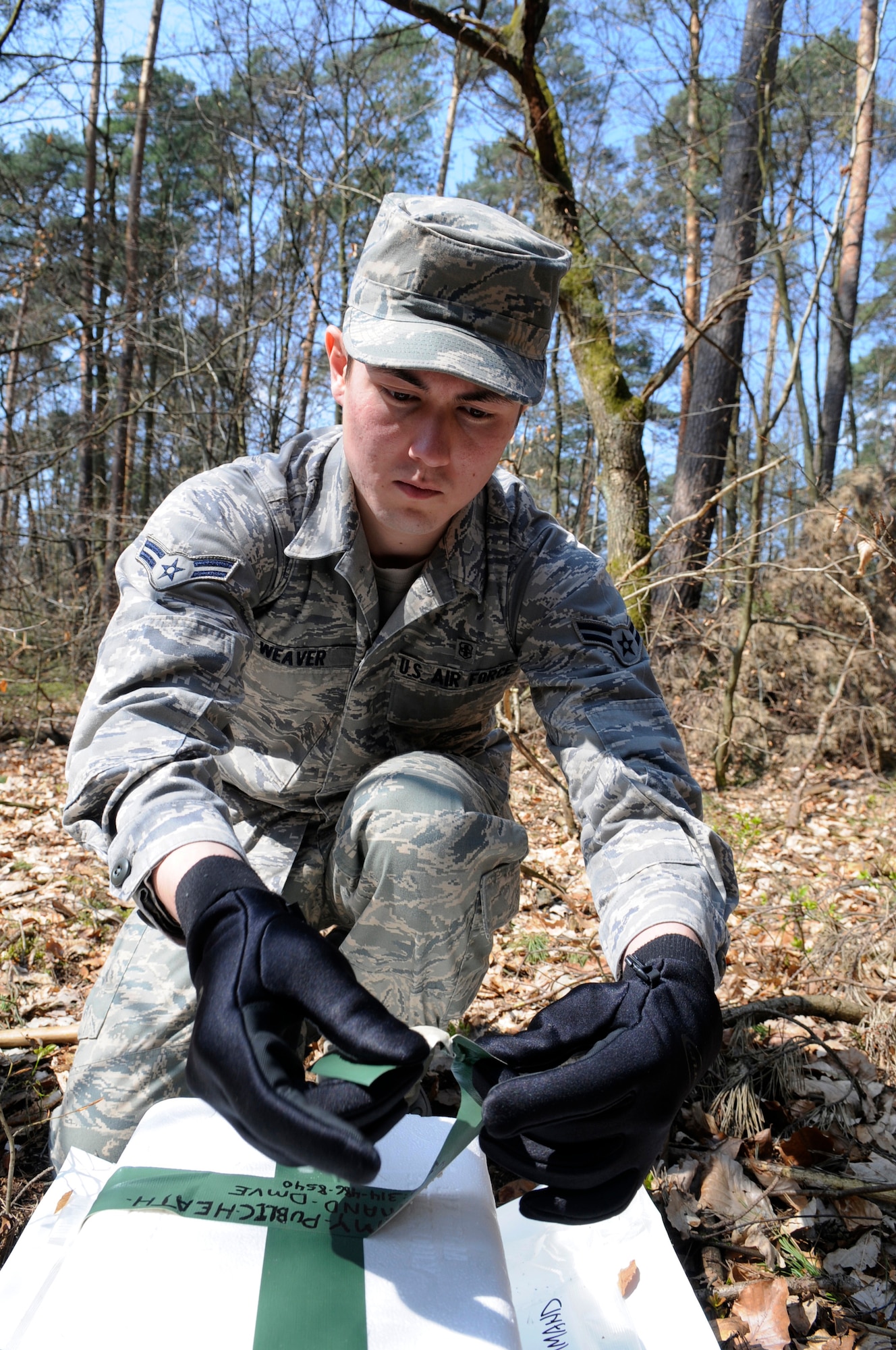 U.S. Air Force Airman 1st Class Earnest Weaver, 86th Aerospace Medical Squadron public health technician, secures a Carbon Dioxide trap to help collect ticks, Ramstein Air Base, Germany, April 16, 2010. The 86th AMDS public health flight on Ramstein has been working with the U.S. Army Public Health Command Region-Europe to conduct surveillance of tick species and tick-borne pathogens in the area. (U.S. Air Force photo by Airman 1st Class Brittany Perry)