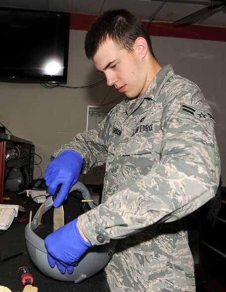 SEYMOUR JOHNSON AIR FORCE BASE, N.C. -- Airman 1st Class Mark Peterson performs maintenance on an aircrew helmet here April 13, 2010. Aircrew helmets receive a complete inspection every 30 days. Airman Peterson, 4th Operations Support Squadron aircrew flight equipment apprentice, hails from Munising, Mich. (U.S. Air Force photo/Airman 1st Class Gino Reyes)