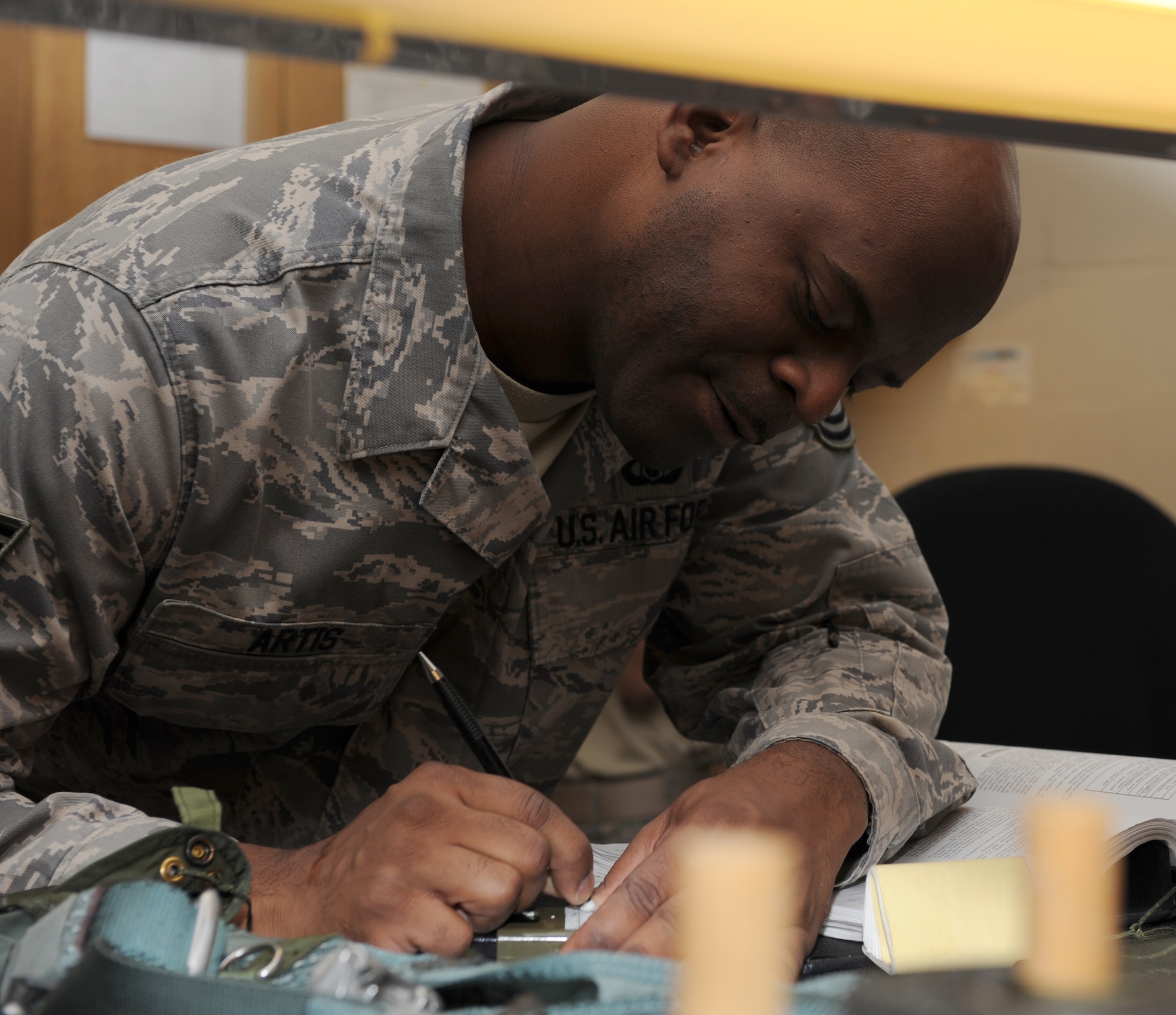 SEYMOUR JOHNSON AIR FORCE BASE, N.C. -- Tech. Sgt. Billy Artis updates equipment records here April 13, 2010. Aircrew flight equipment Airmen must document equipment records every time an item is issued, replaced or inspected. Sergeant Artis, 4th Operations Support Squadron aircrew flight equipment technician, hails from Columbia, S.C. (U.S. Air Force photo/Airman 1st Class Gino Reyes)