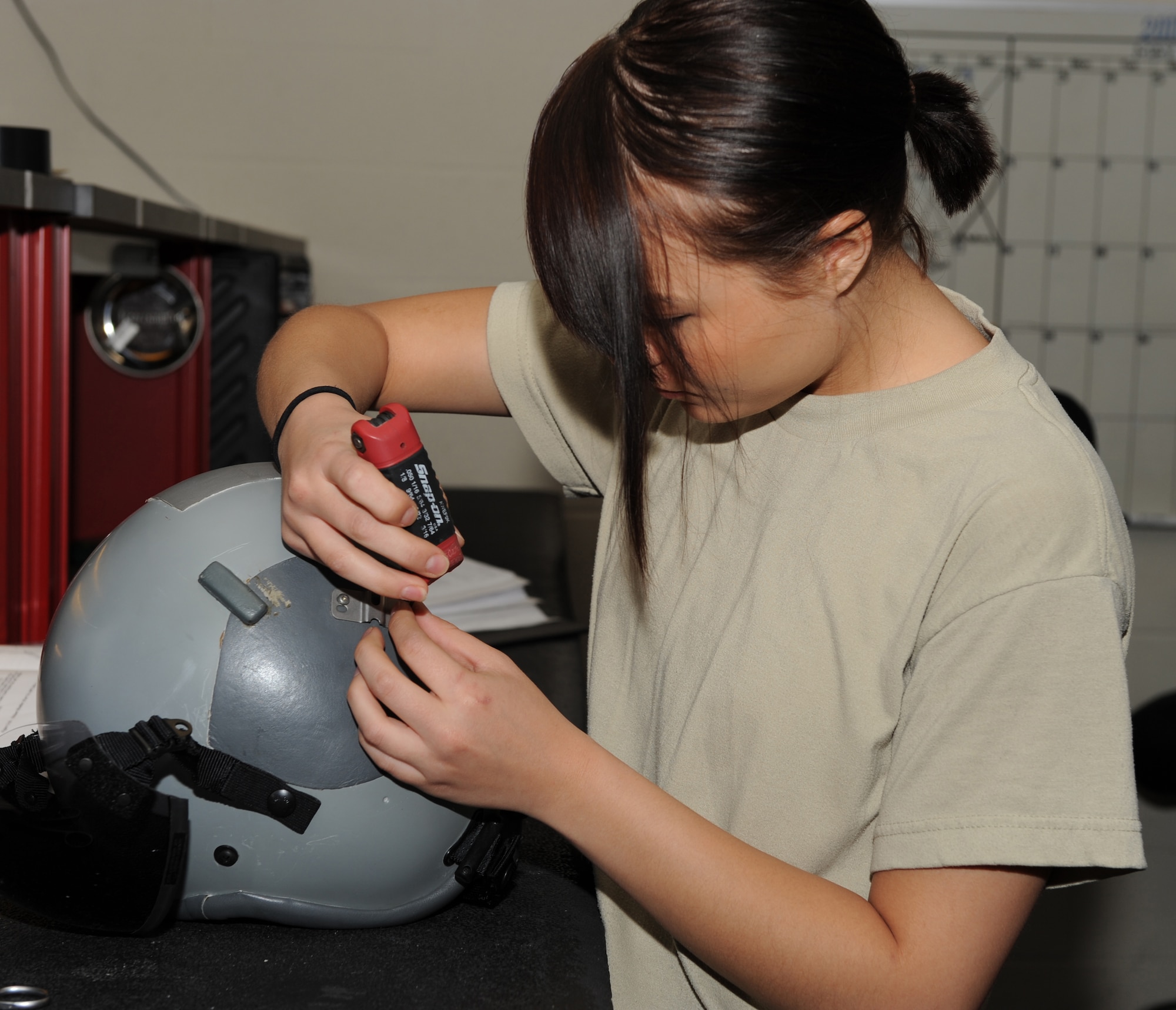 SEYMOUR JOHNSON AIR FORCE BASE, N.C. -- Airman 1st Class Angela Morrow assembles a flight helmet here April 13, 2010. Aircrew flight equipment personnel assemble, inspect and maintain aircrew helmets to make sure they are serviceable. Airman Morrow, 4th Operations Support Squadron aircrew flight equipment apprentice, hails from Ceneca, Mo. (U.S Air Force photo/Airman 1st Class Gino Reyes)