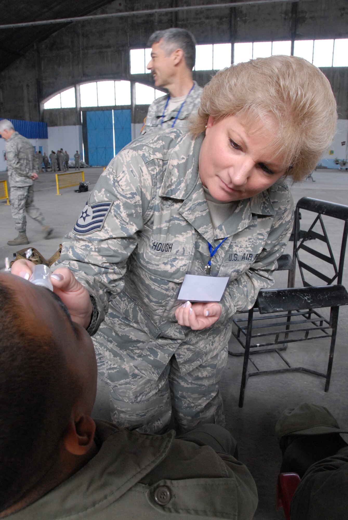Tech. Sgt. Sylvia Hough, a flight equipment specialist assigned to the 153rd Airlift Wing, Wyoming Air National Guard, applies moulage makeup to a Tunisian Army member during exercise MEDLITE-10 at Kharrouba Air Base, Tunisia. Tunisian and American medical personnel work together during the exercise to hone their medical and chemical contamination treatment techniques. (USAF Photo by Master Sgt. Paul Mann/Released) 