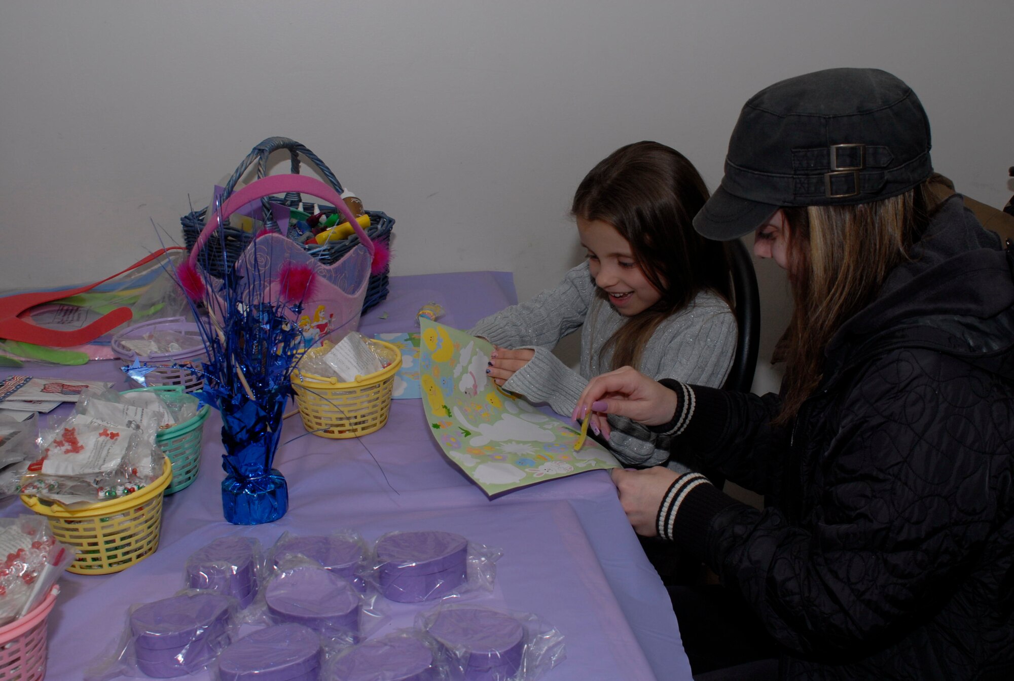 Deena Saccente applies stickers with her daughter Liya Saccente (7), at the arts and crafts table during the 103rd Airlift Wing’s annual Easter Eggstravaganza March 20, 2010, at the dining facility on base. Along with arts and crafts, the children who attended got a special visit by the Easter Bunny, hunted for eggs, participated in a raffle of toys. (U.S. Air Force Photo by Staff Sgt. Erin McNamara)
