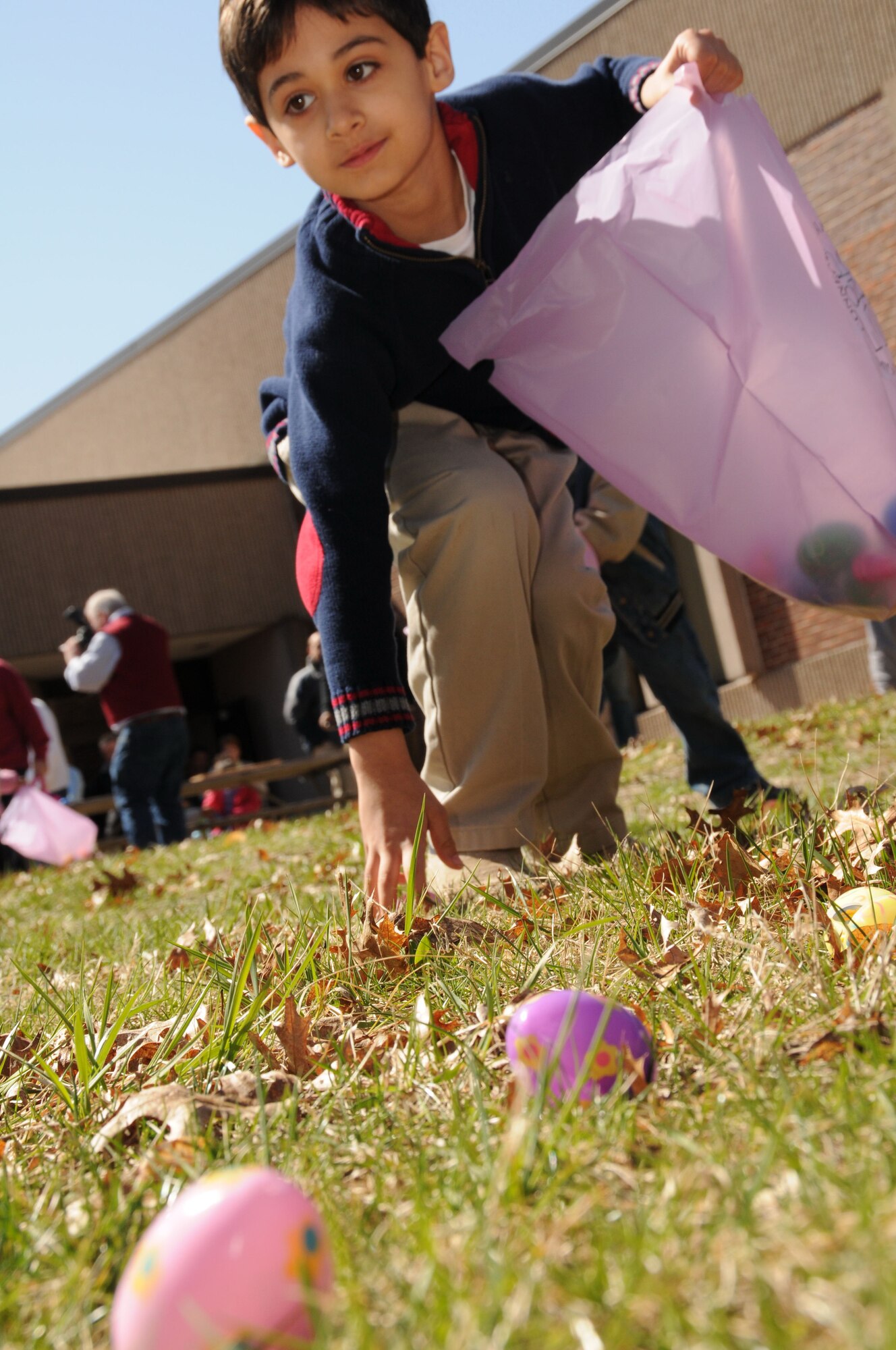 Devin G. Worrall, 7, son of Maj. George Worrall, gets low to grab some Easter eggs during the 103rd Airlift Wing’s annual Easter Eggstravaganza at the Bradley Air National Guard Base, East Granby, Conn. March 27, 2010. The event was held at the base dining facility and involved more than 150 participants and volunteers from the family support program. (U.S. Air Force photo by Staff Sgt. Erin McNamara)