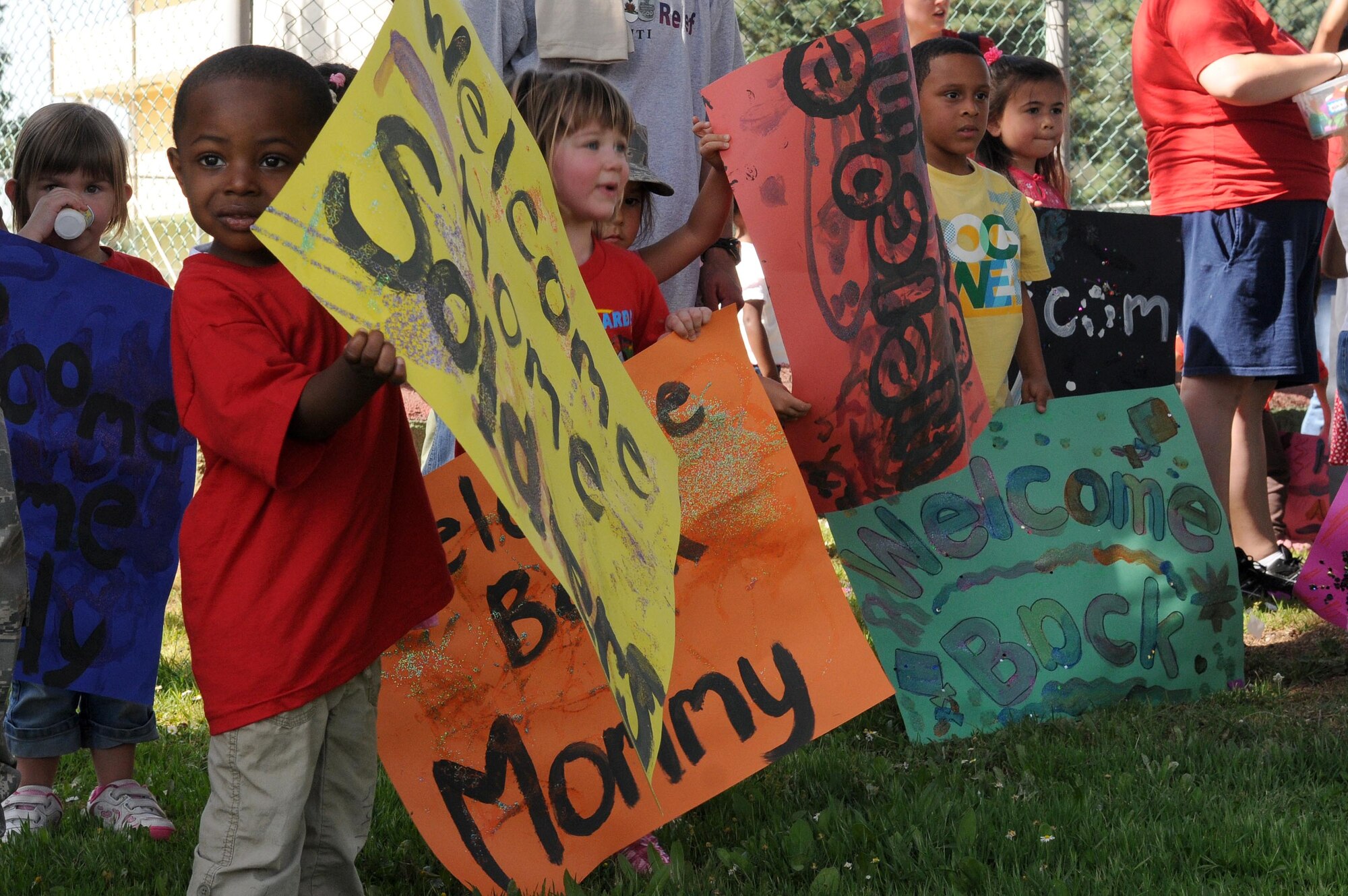 Children from Incirlik’s child development center hold “welcome home” signs for the participants of Operation Born Ready and Trained, a children’s mock deployment, Friday, April 16, 2010 at Incirlik Air Base, Turkey.  Operation BRAT was coordinated by the Airman and Family Readiness Center. (U.S. Air Force photo/Senior Airman Ashley Wood)