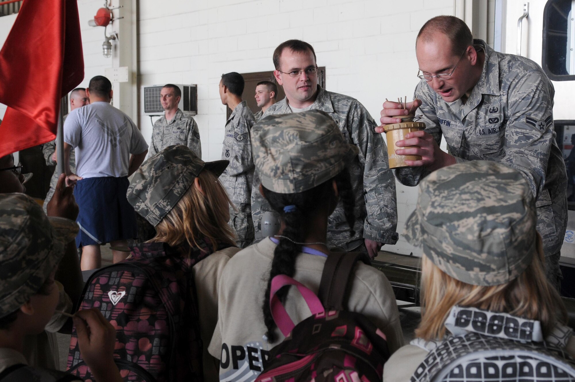 Airman 1st Class Joseph Griffin and Staff Sgt. Seth Hall, 39th Civil Engineer Squadron, show kids a “Bouncing Betty” land mine during Operation Born Ready and Trained, a children’s mock deployment, Friday, April 16, 2010 at Incirlik Air Base, Turkey.  Operation BRAT was coordinated by the Airman and Family Readiness Center. (U.S. Air Force photo/Senior Airman Ashley Wood)