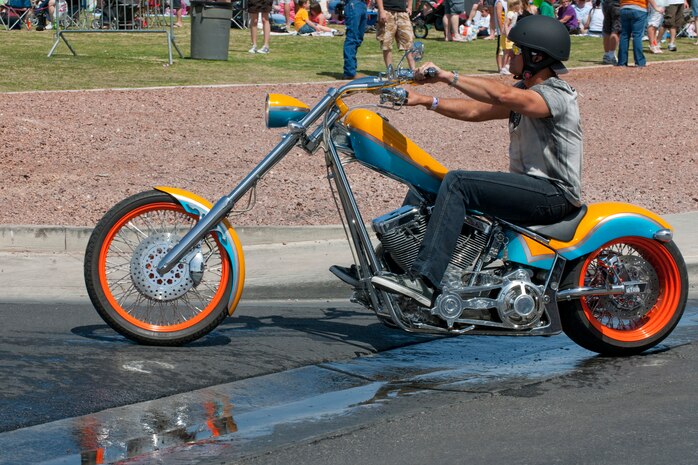 NELLIS AIR FORCE BASE, Nev. --   Singer, Troy Gentry of the country music group "Montgomery Gentry" turns into the parking lot of the Nellis Sports pavilion after riding in the Academy of Country Music Chairman's Ride. Country music stars like Montgomery Gentry and LeAnn Rimes participated in a free concert hosted by the Academy of Country Music's charitable arm "Lifting Lives" and the USO April 17, 2010. (U.S. Air Force photo by Tech. Sgt. Michael R. Holzworth)
