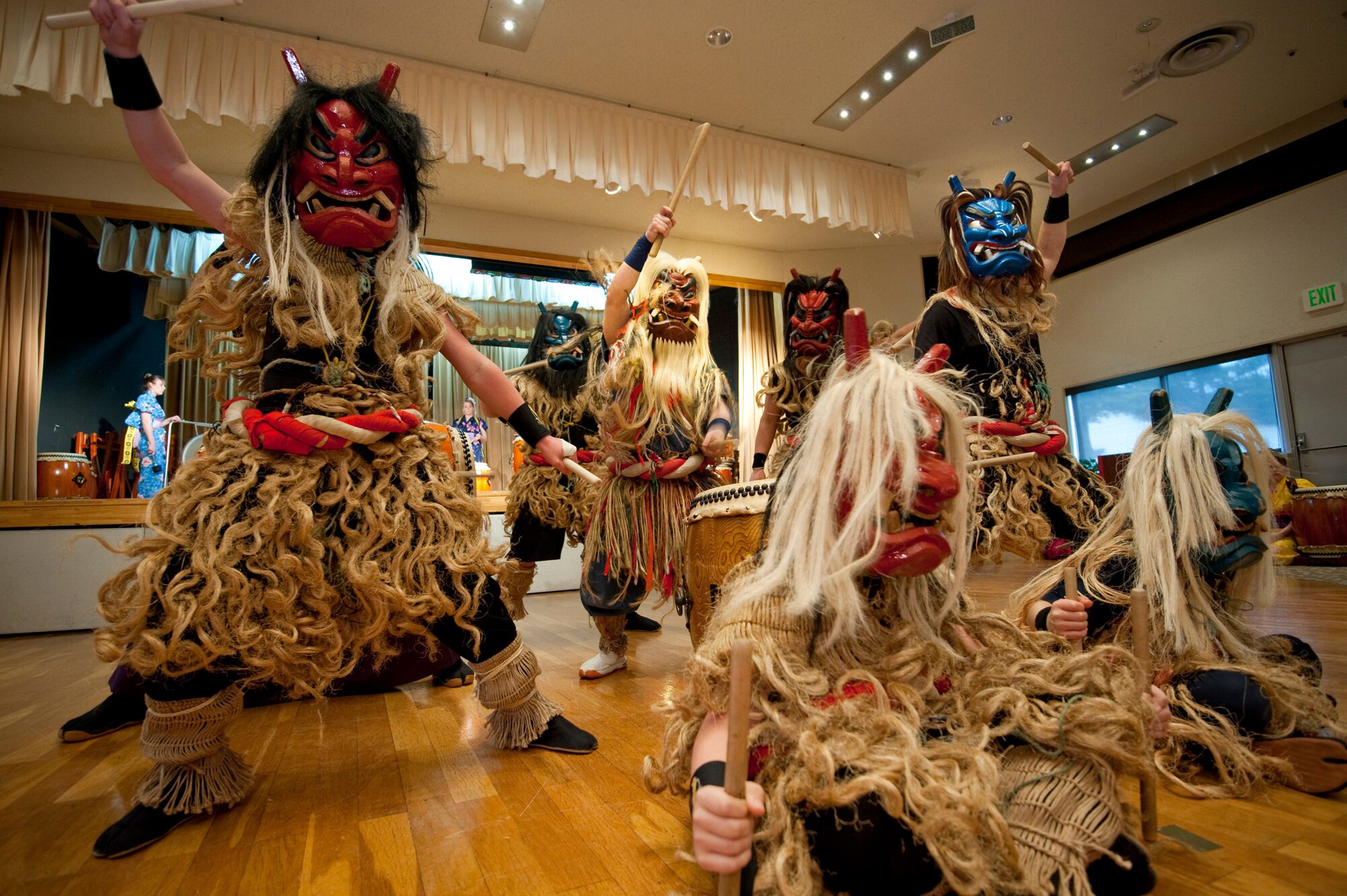 MISAWA AIR BASE, Japan -- Dressed as Japanese mountain spirits called namahage, members of the Dragon Eagle Taiko Team circle around their master taiko teacher, Kiyotaka Hosoi, as he plays a solo during a performance at the Mokuteki Community Center April 17. Mr. Hosoi taught the advanced class of the American team based out of the Lunney Youth Center after being invited by the team's primary teacher, Kazuko Igarashi. This performance of the song "Namahage" marked the 11th anniversary of the team's formation as well as the final performance of Mr. Hosoi with the team. (U.S. Air Force photo/Staff Sgt. Samuel Morse)
