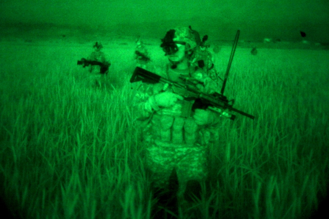 As seen through a night-vision device, U.S. Army soldiers move to an overwatch position in Sabari, Khowst province, Afghanistan, April 6, 2010.