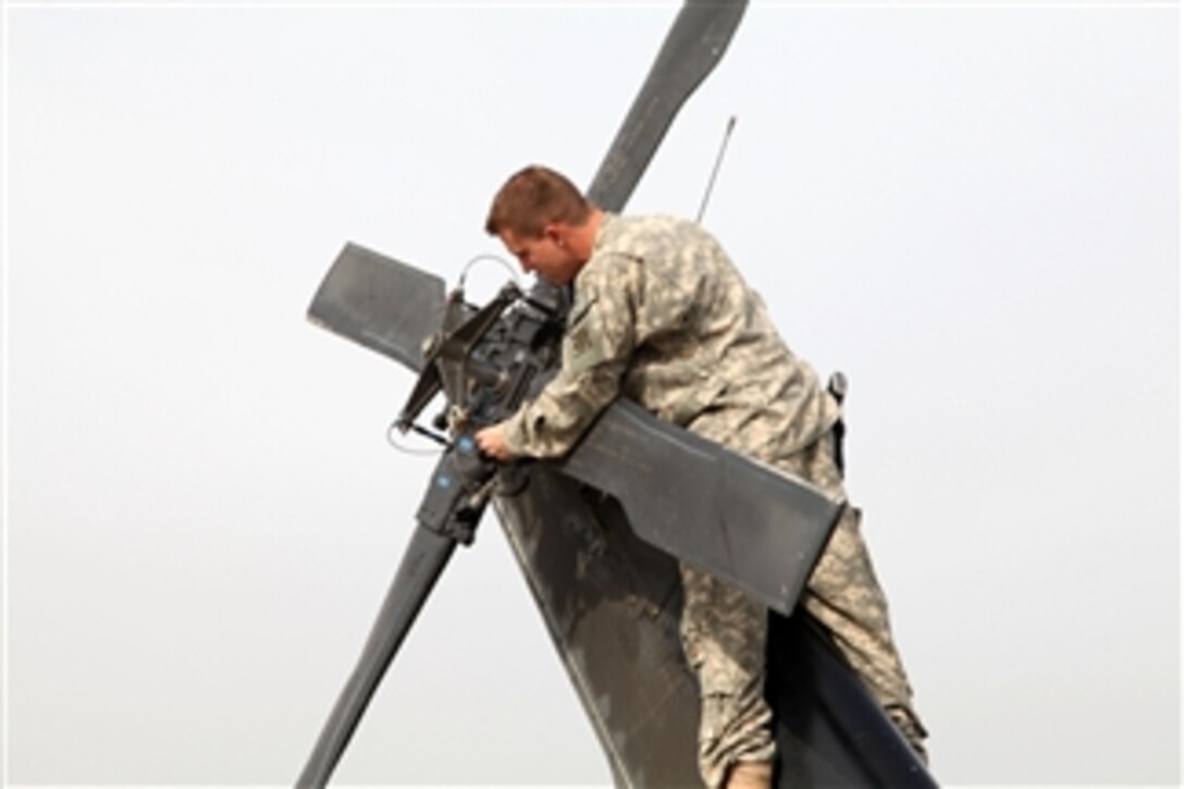 A U.S. Army soldier performs a pre-flight system check on a Black Hawk helicopter before a flight at Forward Operating Base Fenty, Kunar province, Afghanistan, on April 15, 2010.  This Task Force Lighthorse mission includes soldiers from Charlie Company, 4th Battalion, 3rd Aviation Regiment with the 3rd Squadron, 17th Cavalry Regiment, 10th Combat Aviation Brigade, 10th Mountain Division.  The preparations are for a leaflet drop.  