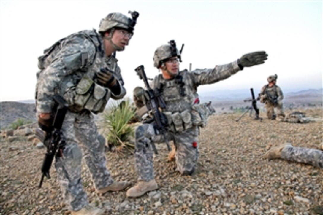 U.S. Army 1st Lt. Nicholas Gregory, kneeling, and Sgt. 1st Class Robert White discuss where to move next in Bak, Khowst province, Afghanistan, April 5, 2010. Gregory and White are assigned to the 101st Airborne Division's Company D, 3rd Battalion, 187th Infantry Regiment, 3rd Brigade. The purpose of the mission was to clear safe houses and search suspected cache sites.