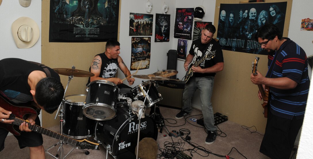 From left, guitarist Cpl. Eddie Martinez, drummer Cpl. Steven Ybarra, guitarist Cpl. Stephen Case and bassist Carlos Correa of the metal band Earth Station Massacre, practice their songs at Ybarra’s home at the Marine Corps Air Station in Yuma, Ariz., April 19, 2010, in preparation for the 6th annual Yuma Battle of the Bands. The band will be competing against 13 other bands May 8 for a $500 first prize.
