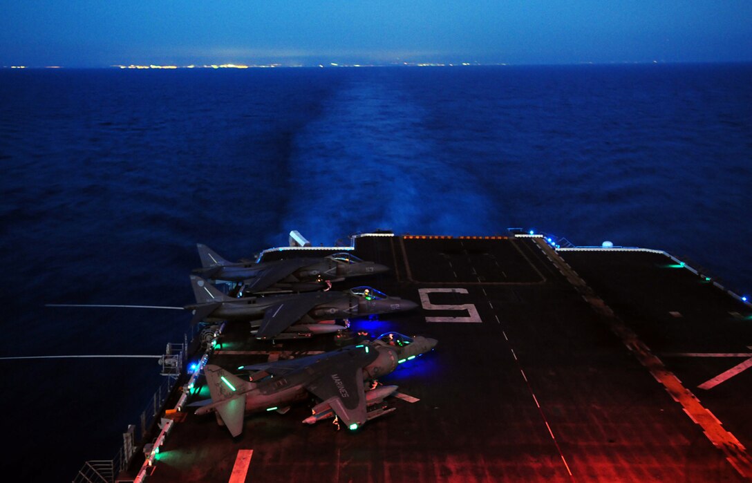 Two Marine Attack Squadron 311 AV-8B Harriers start up at night and prepare to take off from the flight deck of the USS Peleliu April 19, 2010, during the squadron’s final predeployment exercise off the coast of California. Six AV-8B Harriers and approximately 80 squadron Marines left Yuma April 15 to participate in their third and final predeployment training evolution. The exercise, which began April 16 and is scheduled to end April 27, included the entire 15th Marine Expeditionary Unit. The squadron is slated to deploy to the Pacific and Indian Oceans with the 15th MEU in May. The main body of the squadron deployed to Japan aboard the USS Essex with the 31st MEU in January. The last time the squadron deployed with the 15th MEU was in 2008.