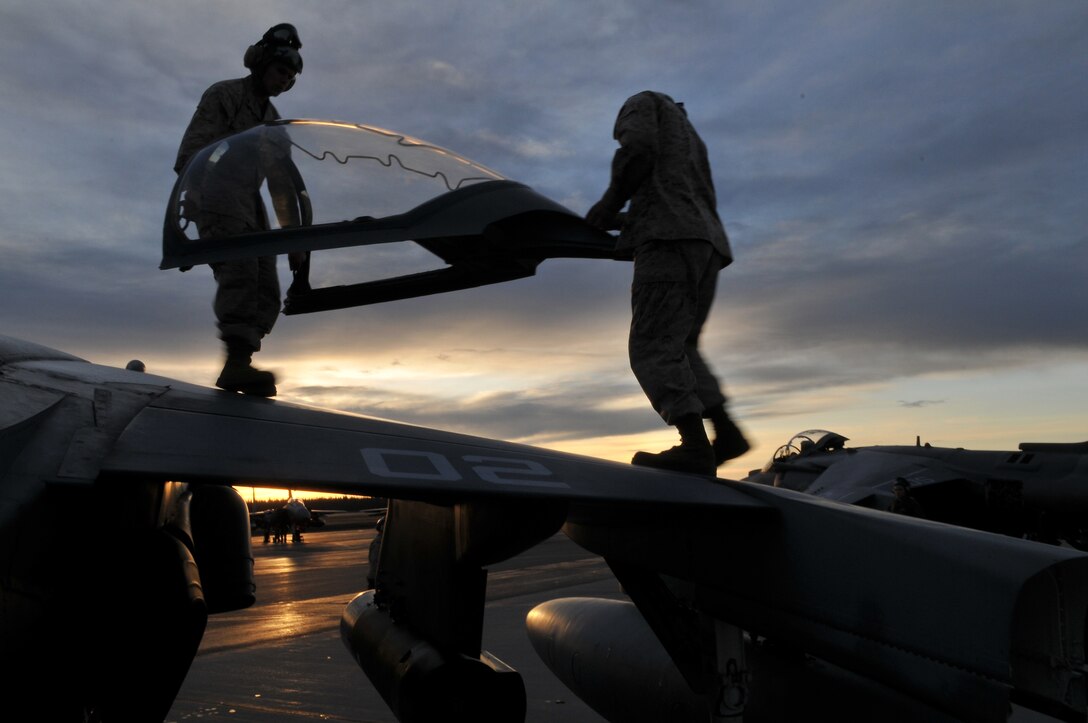 Marine Attack Squadron 211 flight safety equipment mechanics Lance Cpl. Dominik Adamski, left, and Lance Cpl. Charles Hawkins replace a cockpit on one of the squadron's AV-8B Harriers on the flight line of Eielson Air Force Base, Alaska , April 19, 2010. The Yuma-based Marines returned home May 4, 2010, with approximately 165 other VMA-211 Marines after two-and-a-half weeks of aerial warfare training in Exercise Red Flag-Alaska, one of the largest joint-service exercises in the U.S. military.