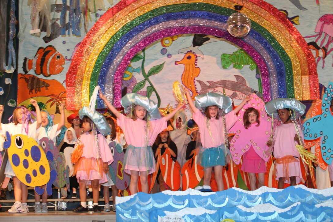 Children dressed as tropical fish, jellyfish and starfish at Johnson Primary School aboard Marine Corps Base Camp Lejeune dance under the rainbow during their spring musical, “Oceans of Fun,” April 20.  The kindergarten, 1st grade and 2nd grade students learned about ocean animals and their habitats in celebration of Earth Day and Month of the Military Child.