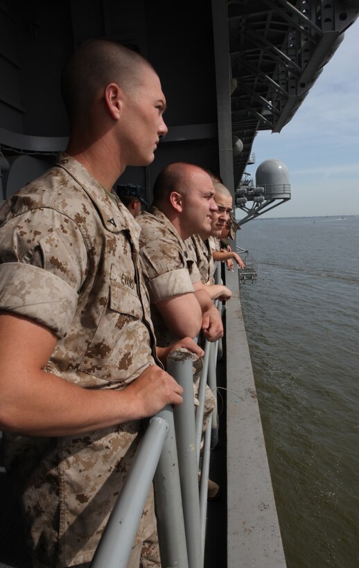 Marines with 26th Marine Expeditionary Unit watch as land on the horizon slips away after USS Kearsarge leaves the dock in Norfolk, Va., April 20, 2010. The Marines are aboard for Amphibious Squadron (PHIBRON)/ MEU Integration training (PMINT). During PMINT, MEU Marines will be introduced to life aboard the ships. They will participate in training exercises on and from USS Kearsarge, USS New York, and USS Carter Hall.