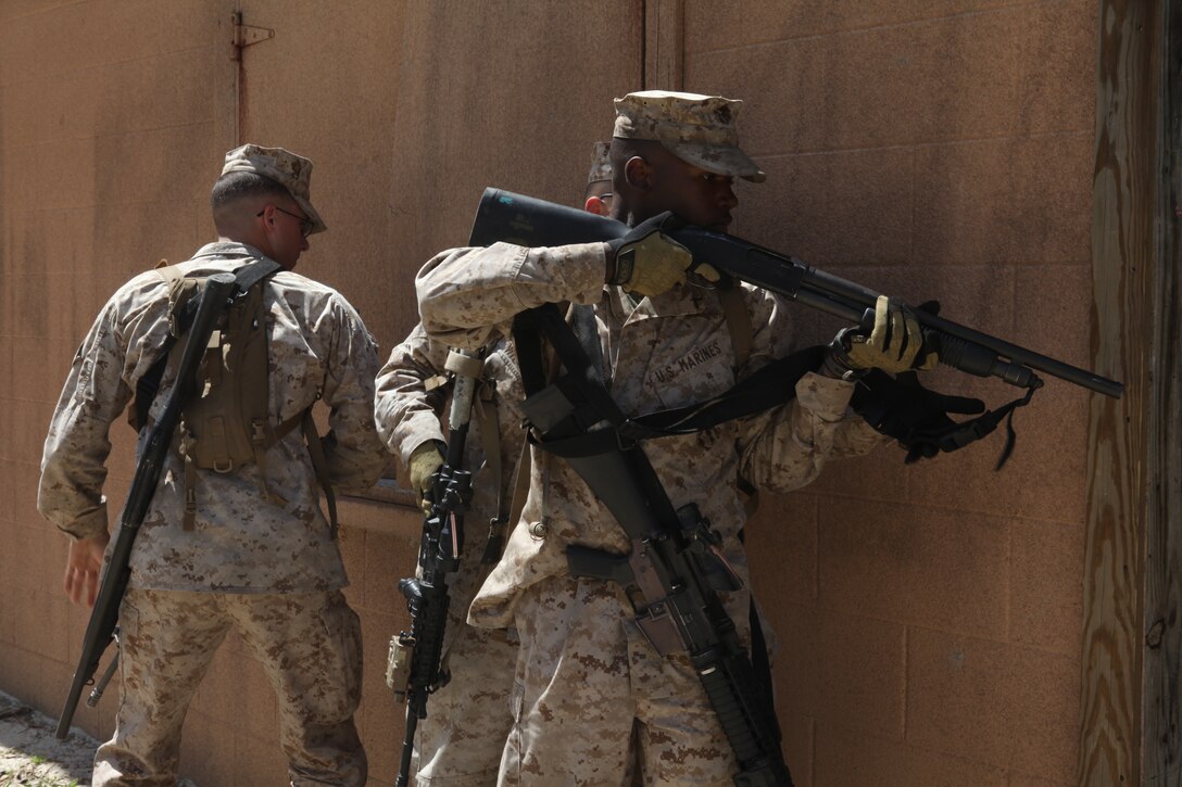 Marines with Company K, Battalion Landing Team 3/8, 26th Marine Expeditionary Unit, practice using a shotgun to breach doors at Combat Town during the Motorized Raid Course aboard Camp Lejeune, N.C., April 20, 2010. The Motorized Raid Course is one of several Special Operations Training Group, II Marine Expeditionary Force events as part of 26th MEU's preparation for deployment this fall.