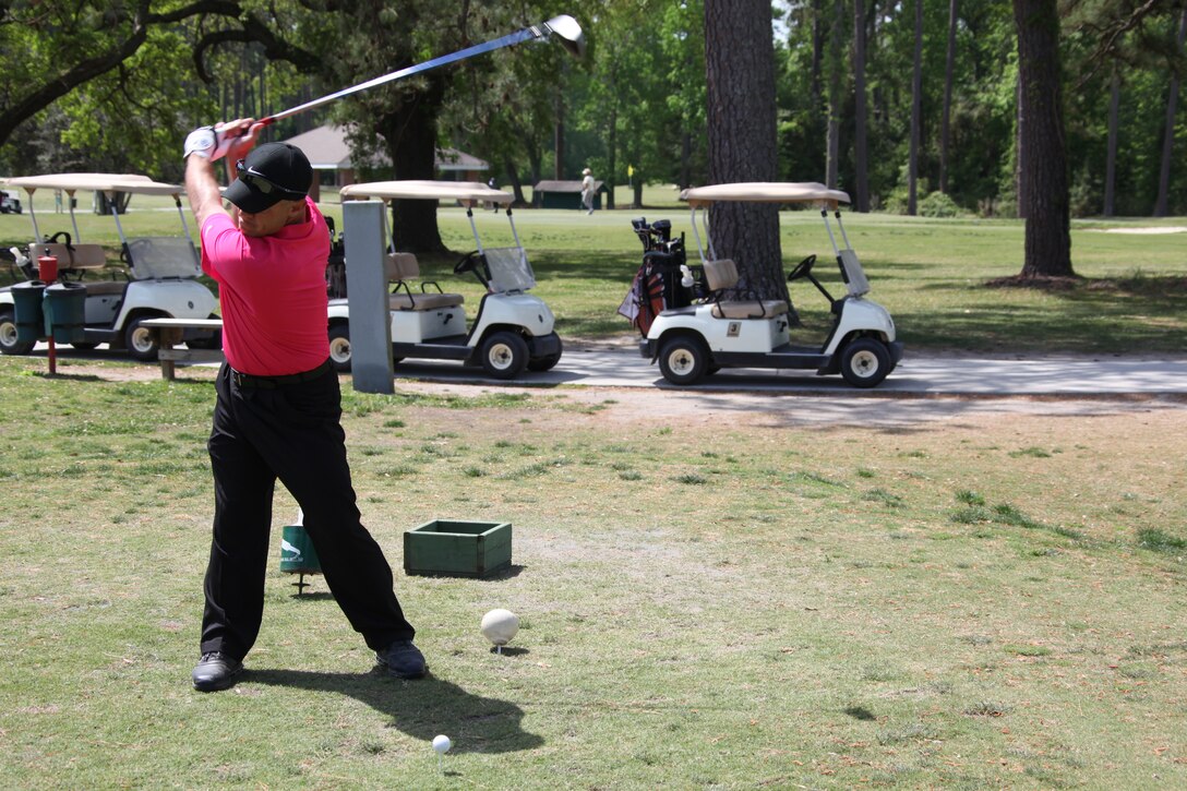 Mick Jones tees off on the first hole of the Navy Marine Corps Relief Society Fundraiser golf tournament at the Sound of Freedom golf course, April 20.  The tournament was a shotgun style, best ball tournament played with four man teams to raise money for NMCRS.