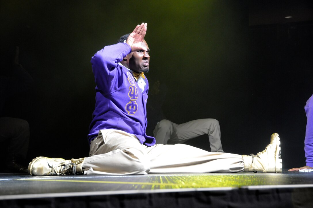 A member of the Omega Psi Phi fraternity gives his salute to a roaring crowd after culminating a complex stomp routine with a special stunt. The Omega Si Phi University of Oklahoma chapter competed in the 2011 OU Stompdown Showcase, sponsored by the Marine Corps, April 30.  As part of their diversity initiative the Marines of Recruiting Station Oklahoma City met with members of the Black Student Association to determine areas in which they could support the black community. This year marked the first time any military service chose to support this event – a fact that has created a positive and mutually- beneficial relationship between the students here and their local Marines.