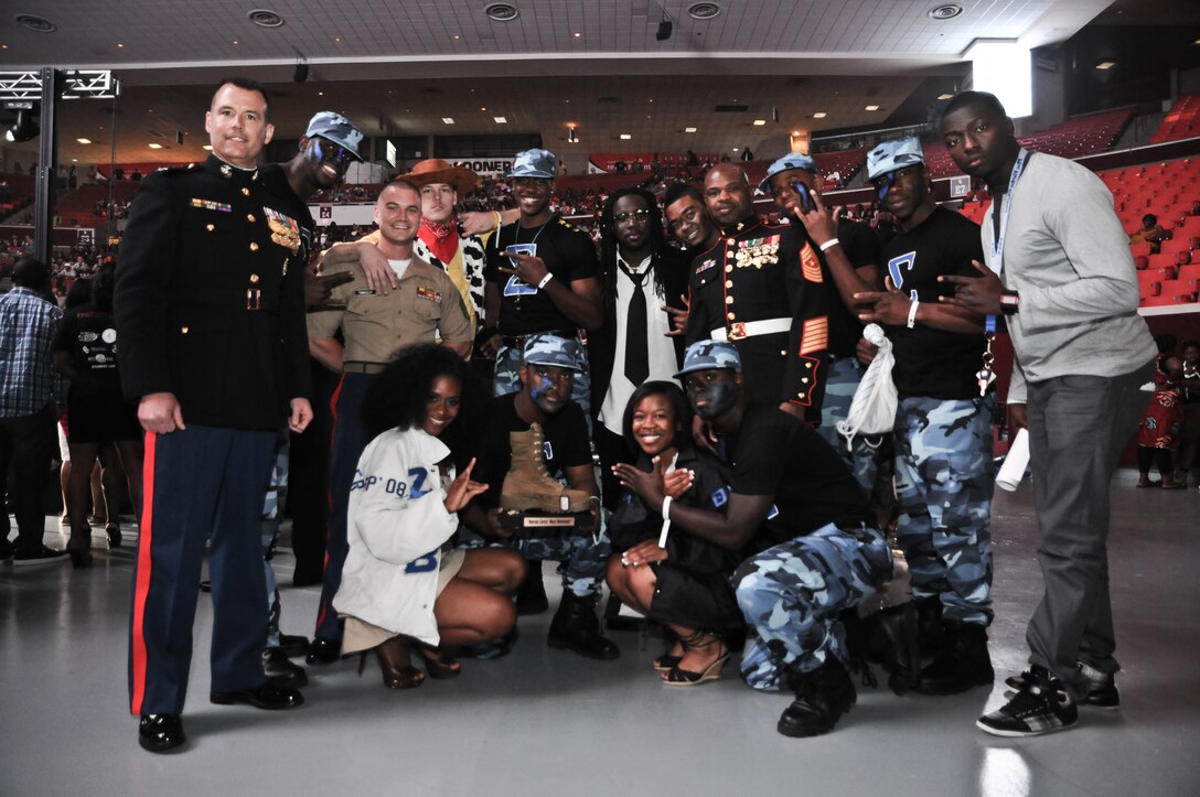 The members of Sigma Phi Beta, University of Oklahoma Chapter, pose with Col. Ted Studdard, (left) commanding officer, 8th Marine Corps District, and Sgt. Maj. J.B. Edwards (eighth from left) after the Marines presented them with the "Marine Corps' Most Motivated Award” at the 2011 Stompdown Showcase, April 30. ::r::::n::The Marines presented the award to the team they thought most motivated the crowd. The Sigma Phi Betas went on to win the entire Stompdown competition. This year marked the first time any military service has supported the event.::r::::n::