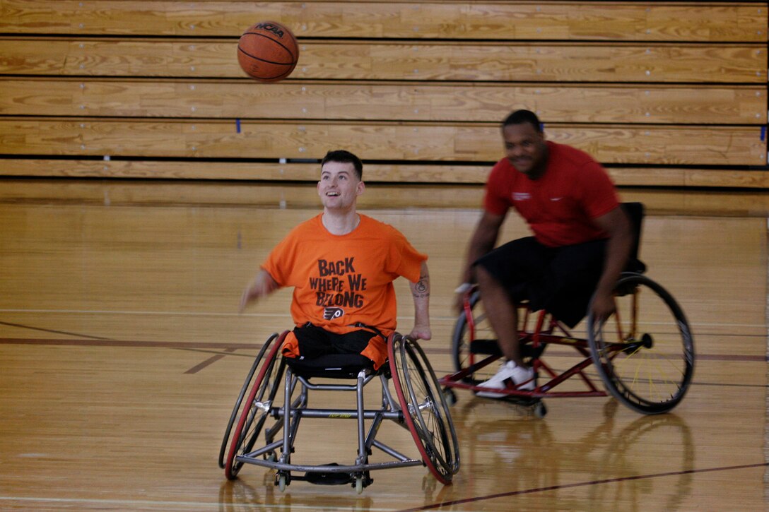 Cpl. Ray Hennagir and Lance Cpl. Justin Knowles, teammates on the Marine Corps’ wheel chair basketball team, participate in a scrimmage against other Marines at Walter Reed’s Wagner Sports Center April 20, 2010. The team is preparing for the Warrior Games in Colorado Springs, Colo., this May.