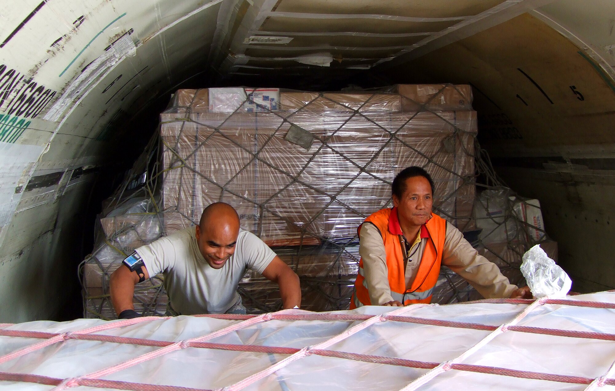 Tech. Sgt. Nelson A. Pineda, Detachment 3, Pacific Air Forces Air Postal
Squadron, removes pallets of mail while deployed to Joint Base Balad, Iraq.
Sergeant Pineda was recognized as the Air Force's Outstanding Postal Service
NCO for 2009. (Courtesy photo)
