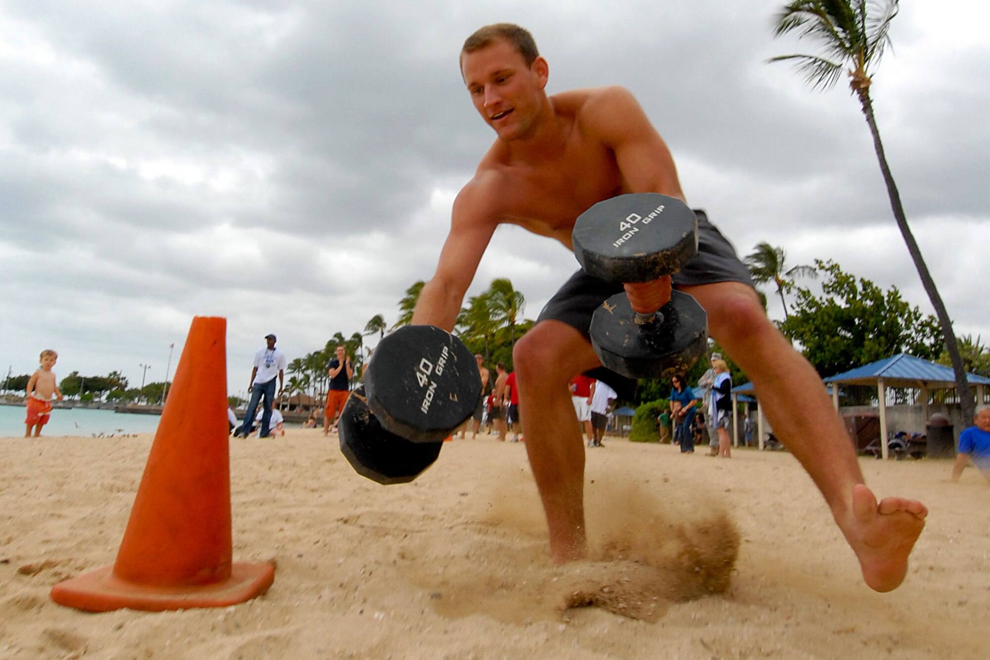 JOINT BASE PEARL HARBOR HICKAM, Hawaii ? 1st Lt. Jimmy Arnold, 535th Airlift Squadron, drops the 40-pound dumbbells during the fitness challenge at Hickam's annual Sports Day April 16. The 535th AS won the event with a time of 6:15. The 324th Intelligence Squadron turned in the second best time at 6:21 and the 15th Operations Support Squadron turned in a sub-seven minute time to take third. Other members of the team are Captains Traci Shiraishi, Mark Fischer and Matt Horner. (U.S. Air Force photo by Staff Sgt. Mike Meares)