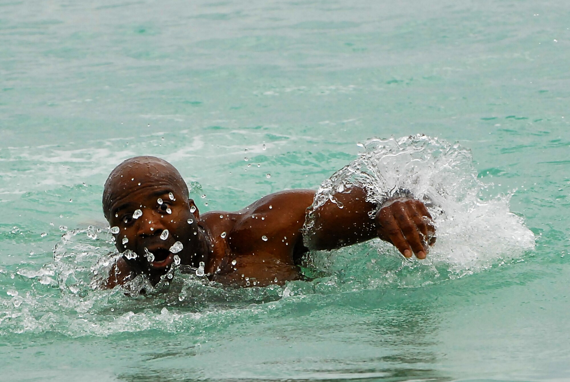 JOINT BASE PEARL HARBOR HICKAM, Hawaii ? Lt. Col. Jarvis Baker, 15th Comptroller Squadron, powers through the salty waters of Hickam Harbor during the swim portion of the fitness challenge at Hickam's annual Sports Day April 16. The 535th Airlift Squadron won the event with a time of 6:15. The 324th Intelligence Squadron turned in the second best time at 6:21 and the 15th Operations Support Squadron turned in a sub-seven minute time to take third.  (U.S. Air Force photo by Staff Sgt. Mike Meares)