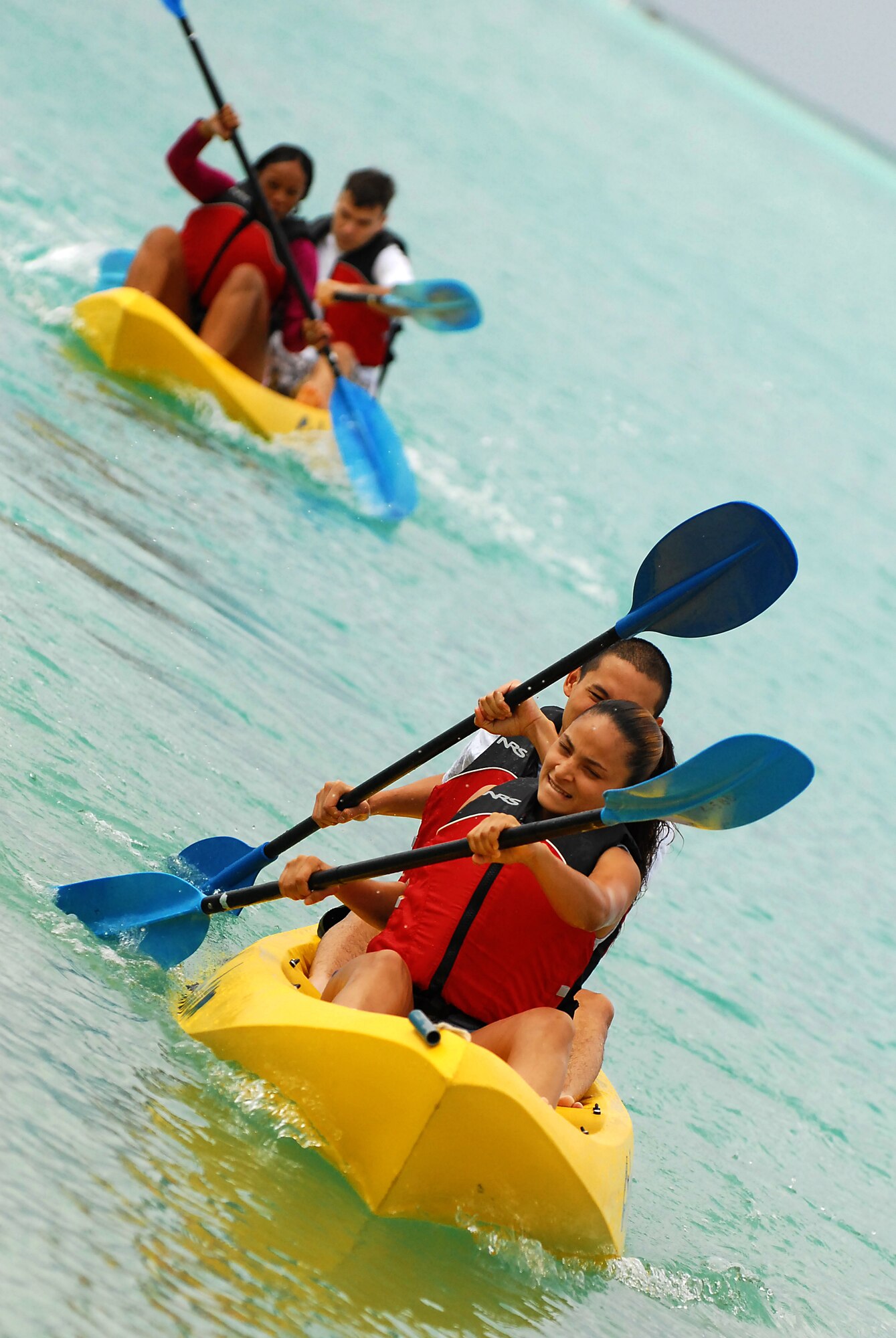 JOINT BASE PEARL HARBOR HICKAM, Hawaii -- Airmen 1st Class Stephany Sanchez and Doddy Burhannudin, 15th Force Support Squadron, paddle in unison to finish the kayak during Hickam's annual Sports Day at Hickam Harbor April 16. The 735th Aircraft Maintenance Squadron beat the 535th Airlift Squadron by two tenths of a second to claim the first spot. The 15th Operations Support Squadron turned a time of :59 to take third place during the three team playoff. The 15th OSS recorded the best time overall of :55 on their first run. Airmen Sanchez and Doddy finished with a time of 1:29. (U.S. Air Force photo by Staff Sgt. Mike Meares) 