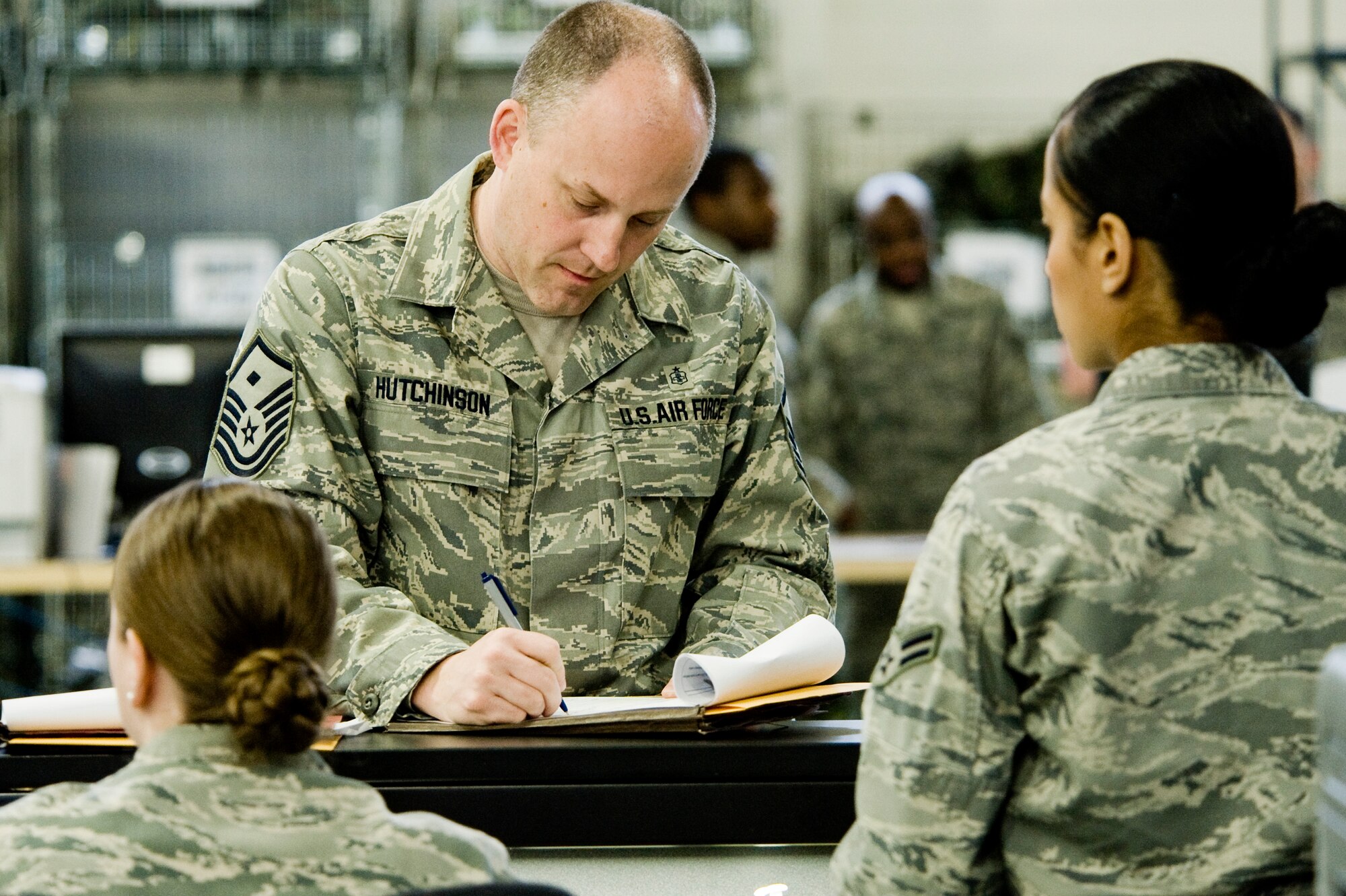 Master Sgt. James Hutchinson, 8th Airlift Squadron, completes paperwork at the Logistic Readiness Squadron mobility warehouse April 20 in preparation for an upcoming deployment. MSgt Hutchinson is the 8th Airlift Squadron First Sergeant. (U.S. Air Force Photo by Abner Guzman)
