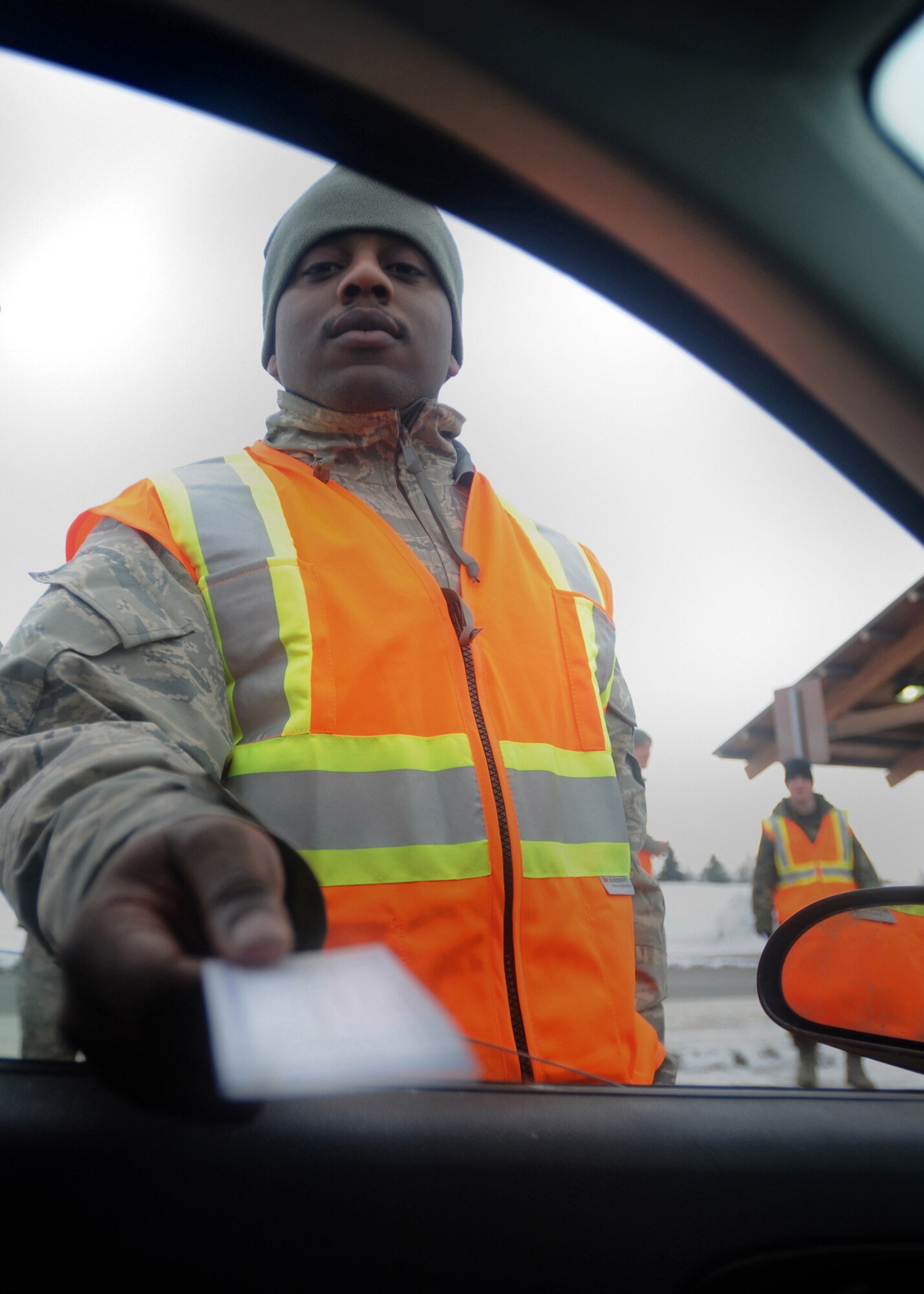 ELMENDORF AIR FORCE BASE, Alaska -- Airman Ryan McKoy, 3rd Civil Engineer Squadron, ensures Airmen have a back-up plan for their weekend activities by passing out Wingman Pledge Cards. The cards contain a pledge to not drink and drive and have  numbers to call when in need of a ride. (Air Force photo by Senior Airman Kristin High)