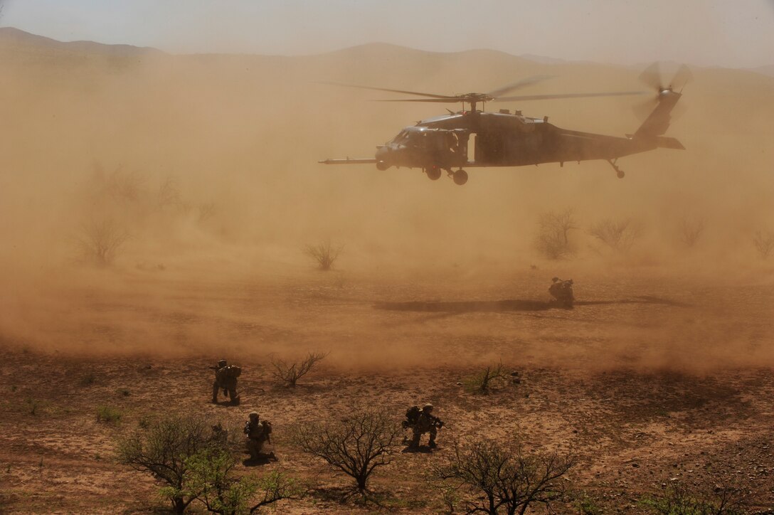 An HH-60 Pave Hawk crew drops off pararescuemen April 15, 2010, during exercise Angel Thunder 2010 in the desert surrounding Davis-Monthan Air Force Base, Ariz. The Pave Hawk crew is from the Alaska Air National Guard's 210th Rescue Squadron at Kulis Air National Guard Base in Anchorage, Alaska. The pararescue crew is from the 103rd RQS in Long Island, N.Y. (U.S. Air Force photo/Staff Sgt. Joshua L. DeMotts)


