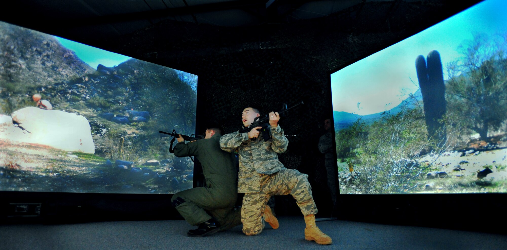 Capt. Joe Wall observes as Master Sgt. John MacDonald engages a "knife-wielding attacker" April 15, 2010, in the 621st Contingency Response Wing's new virtual firearms training simulator at Joint Base McGuire-Dix-Lakehurst, N.J.  Captain Wall is the 21st Air Mobility Operations Squadron Integration Flight commander and Sergeant MacDonald is the 819th Global Support Squadron Force Protection Flight NCO-in-charge.  (U.S. Air Force photo/Tech. Sgt Parker Gyokeres)