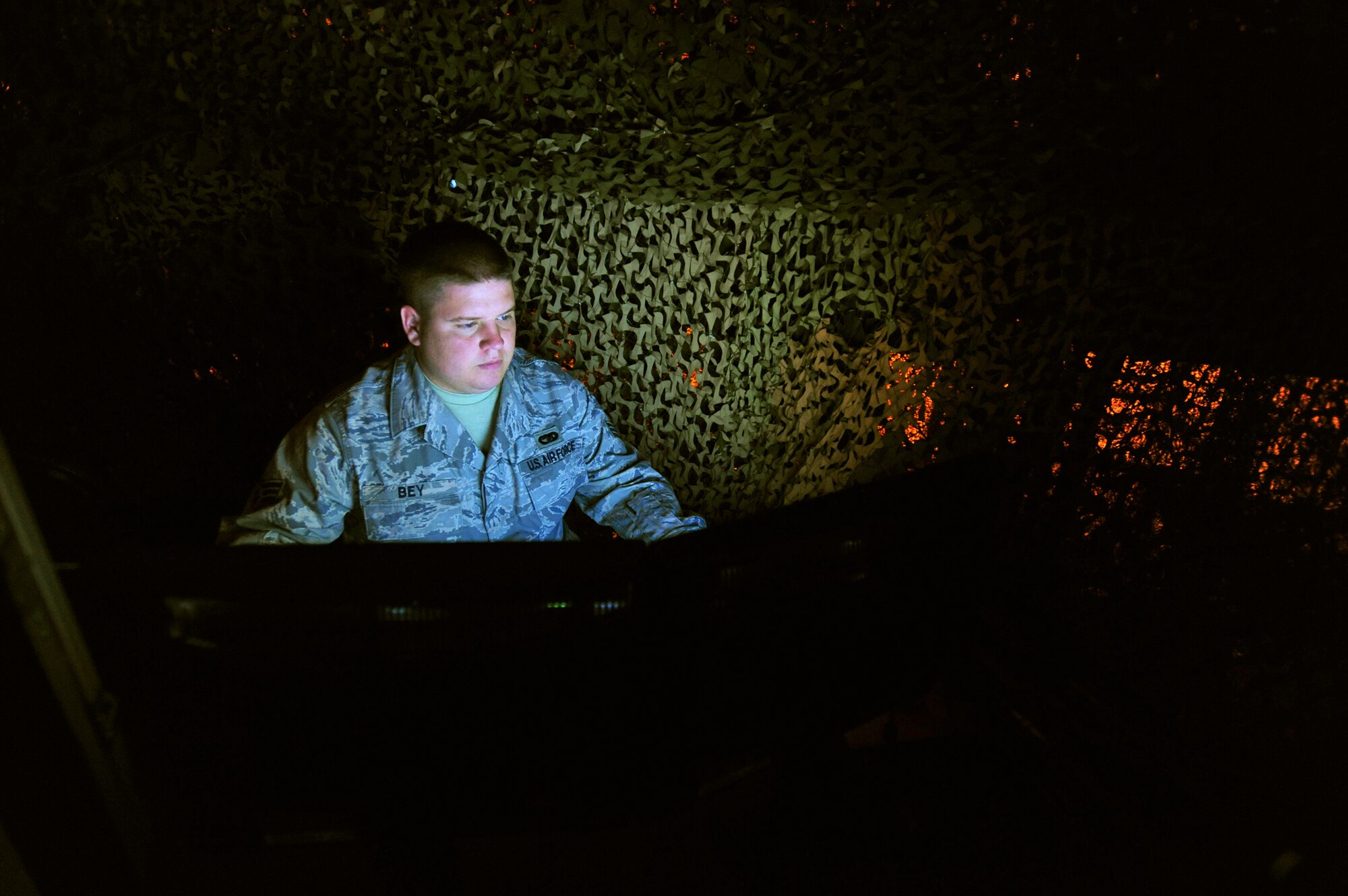 Senior Airman Jeremy Bey operates the 621st Contingency Response Wing's new virtual firearms training simulator at Joint Base McGuire-Dix-Lakehurst, N.J.  The $250,000 system uses light sensors and sophisticated image processors to create an immersive reactive training environment.  Airman Bey is an 819th Global Support Squadron Force Protection trainer.  (U.S. Air Force photo/Tech. Sgt Parker Gyokeres)