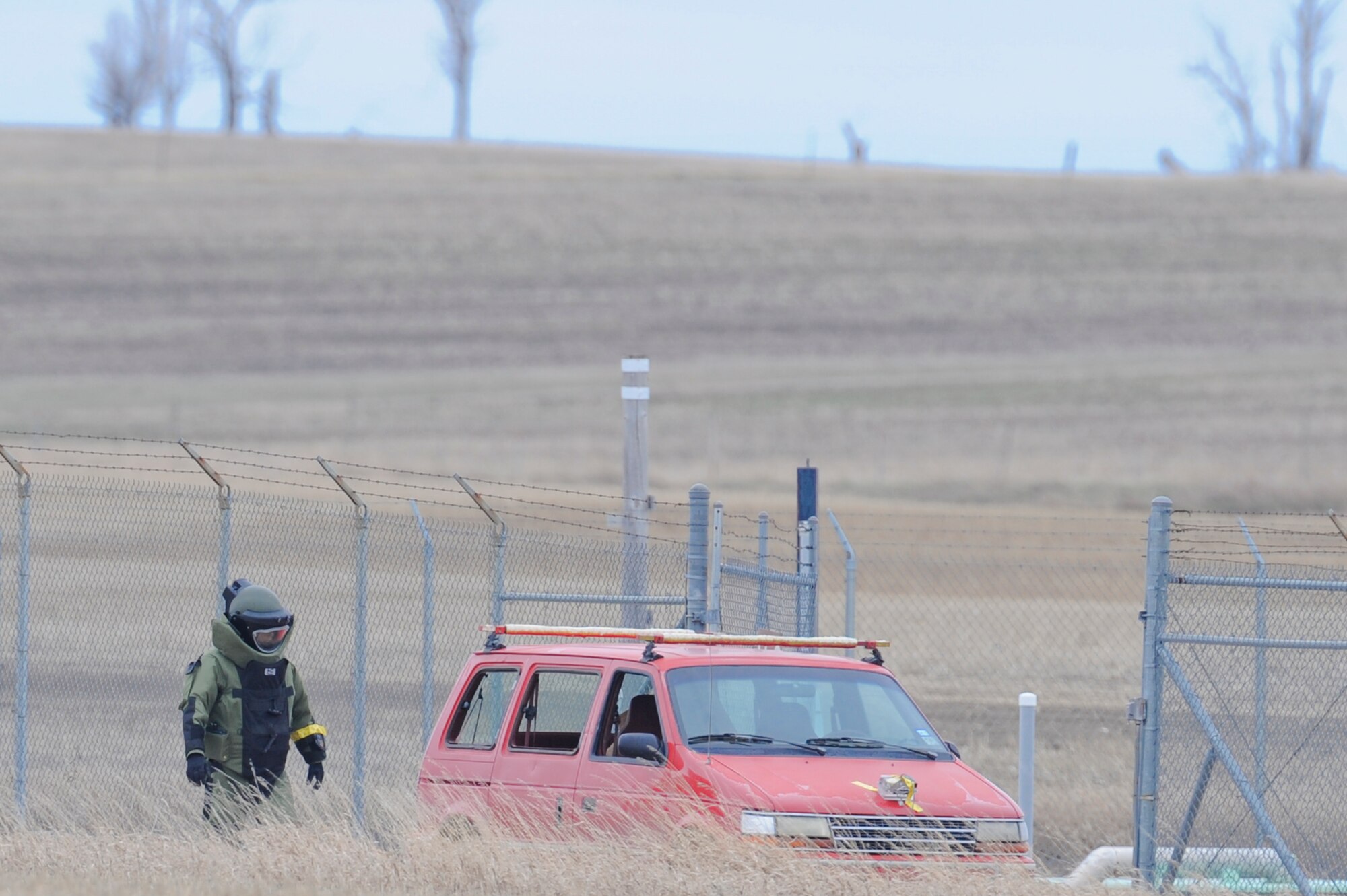 NEAR PARSHALL, N.D. – A member of the 5th Civil Engineer Squadron’s Explosive Ordnance Disposal team finishes placing a charge on a protestor’s vehicle at the H-08 Minuteman III launch facility near Parshall, N.D., April 15. The EOD team was part of coordinated actions from the 91st Missile Wing and the 5th Bomb Wing after Security Forces determined a man had crawled over the fence of the LF as a sign of protest. (U.S. Air Force photo by Staff Sgt. Keith Ballard)